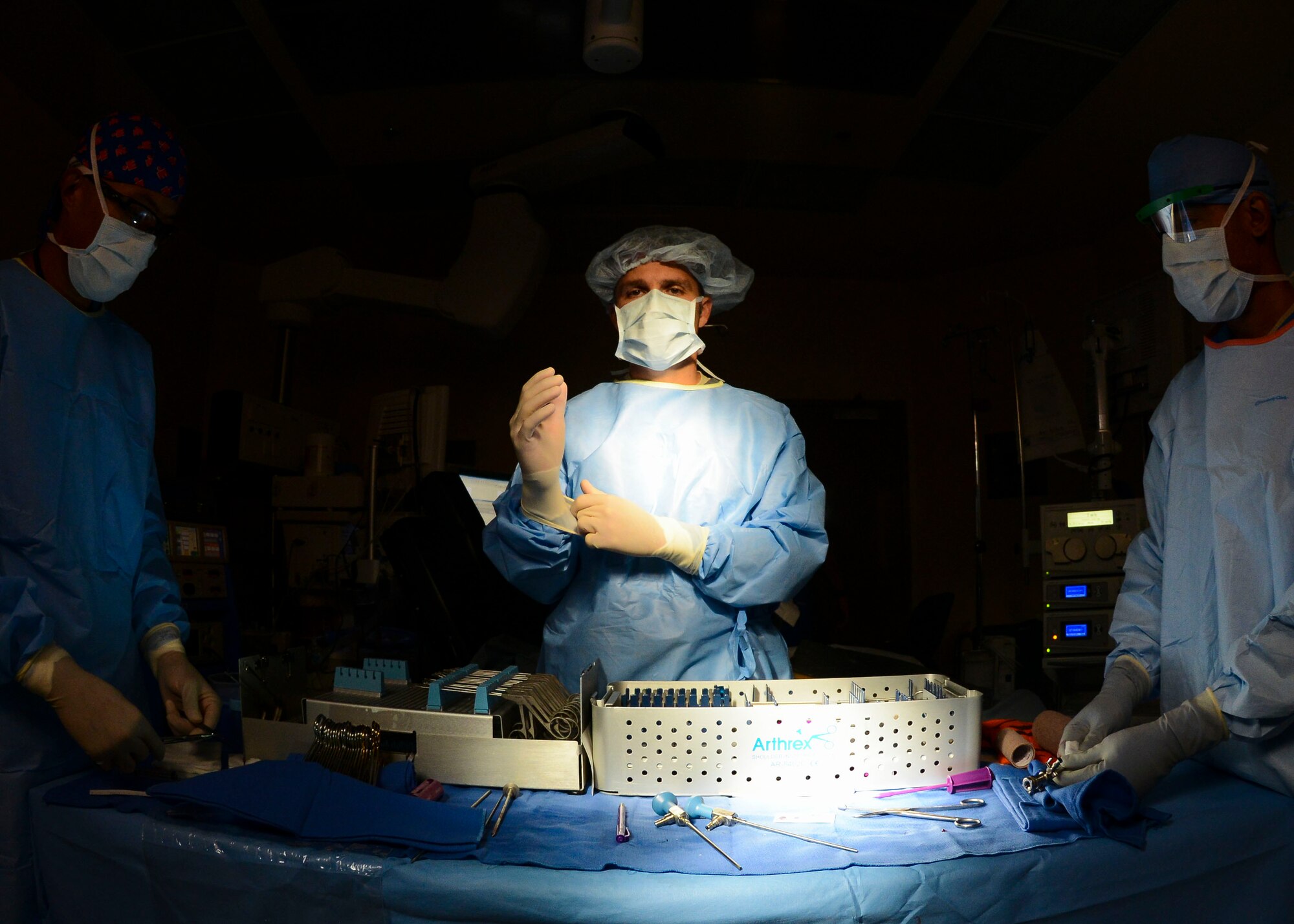 U.S. Air Force Lt. Col. Mark Slabaugh, 31st Surgical Squadron orthopaedic surgeon, dons protective surgical equipment in the operating room, Aug. 20, 2015, at Aviano Air Base, Italy. Slabaugh performs approximately 20 surgeries a month like gall bladder removal, caesarian sections or three-hour-long knee surgeries. (U.S. Air Force photo by Senior Airman Austin Harvill/Released)