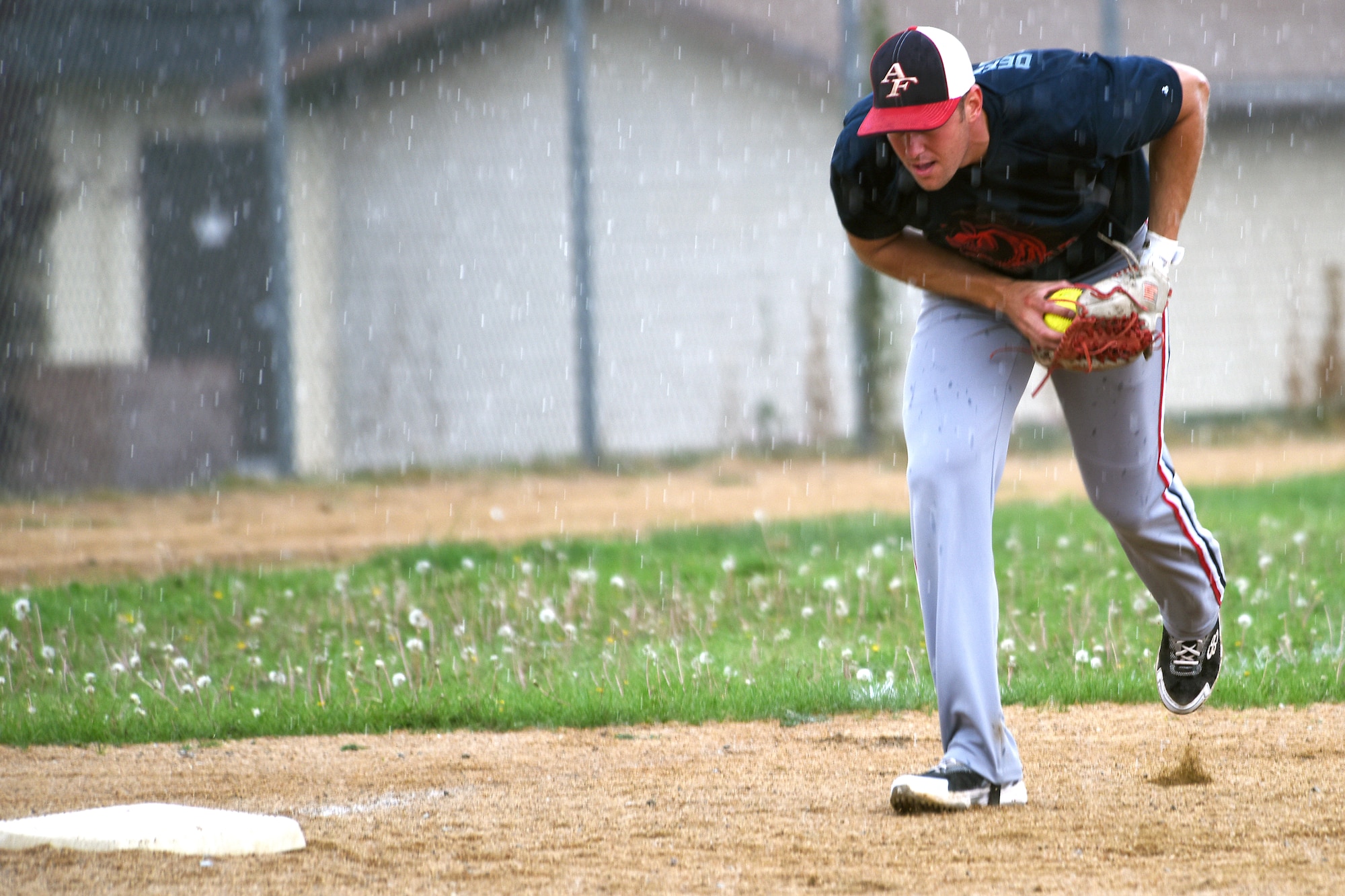 Staff Sgt. Jimmy Fulcher, 341st Security Forces Group evaluator, practices on the baseball field Aug. 17, 2015, at Malmstrom Air Force Base, Mont. Fulcher has been training to try out for the Air Force men's softball team.  (U.S. Air Force photo/Chris Willis) 