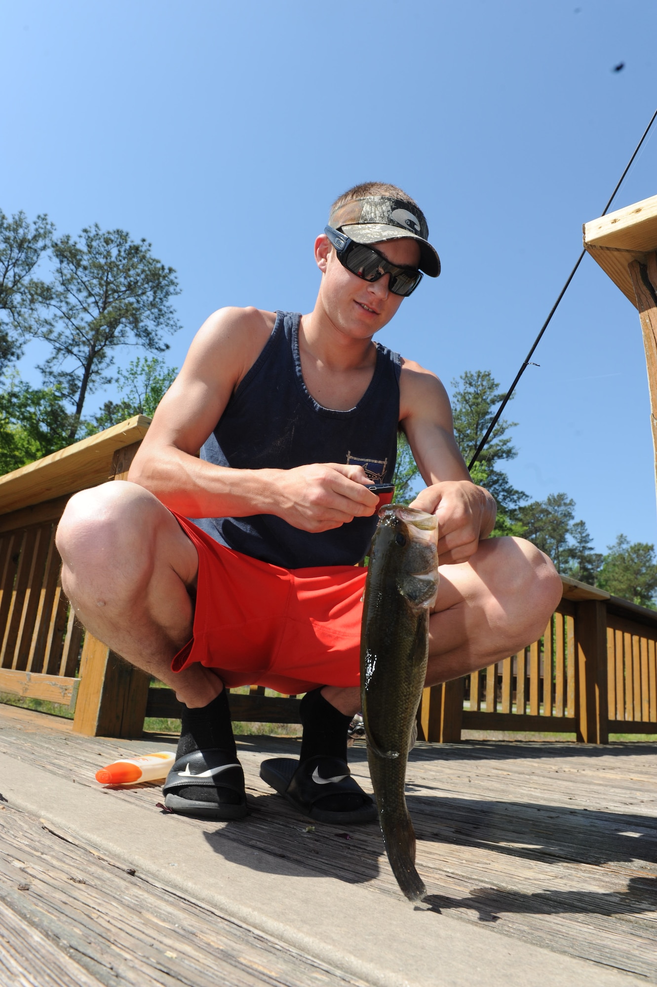 Bryan Lowrey takes a look at the one that didn’t get away at Luna Lake. The 22-acre site offers beautiful scenery and a play to relax and try your hand at fishing. (U.S. Air Force photo by Tommie Horton)