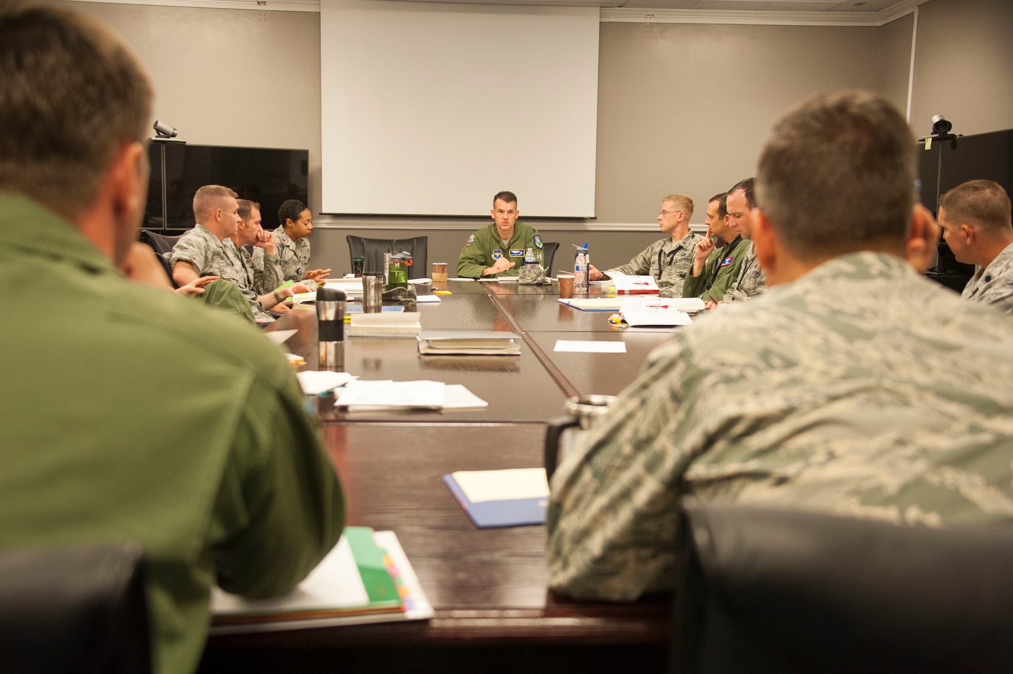 Lt. Col. Jeffrey Donnithorne, Deputy Director of the Center for Strategy and Technology,(center) leads Air Command and Staff College students in a discussion in the new Secure Research Wing at Maxwell Air Force Base, Aug. 18, 2015. The new research facility provides a protected area for Air University students and faculty to access current Air Force doctrine as well as secure computer and video teleconference systems for collaboration and research. (U.S. Air Force photo by Tech. Sgt. Sarah Loicano/Released)
