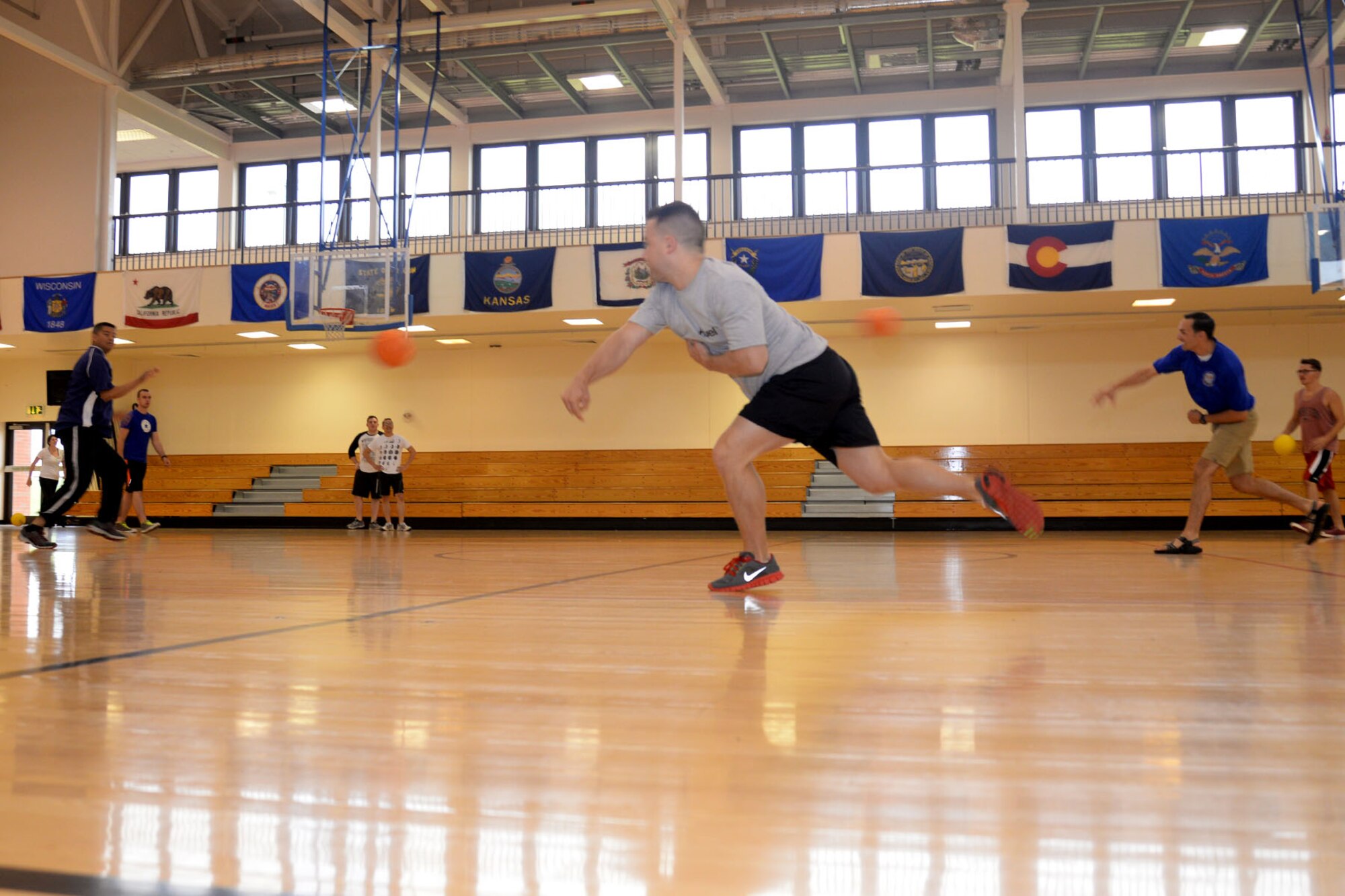 Members of the 95th Reconnaissance Squadron play dodgeball during the 95th RS birthday celebration Aug. 20, 2015, on RAF Mildenhall, England. The squadron celebrated their 98th year of service with a series of events designed to educate and entertain Airmen and families who attended. (U.S. Air Force photo by Senior Airman Kate Thornton/Released)