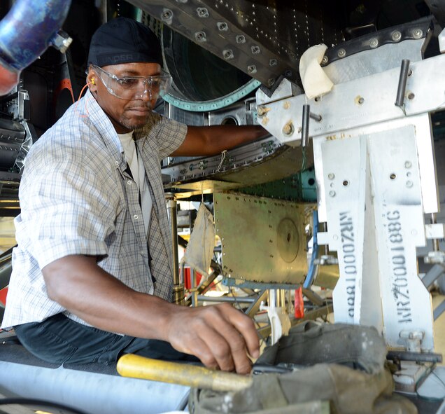 Dennis Pickett, 561st Aircraft Maintenance Squadron aircraft structural repair technician, installs fasteners into the newly replaced 626 bulkhead of an F-15C. During programmed depot maintenance, a crack was discovered in the original bulkhead leaving the organization with the option to replace the part or scrap the entire aircraft. (U.S. Air Force photo/Tommie Horton) 