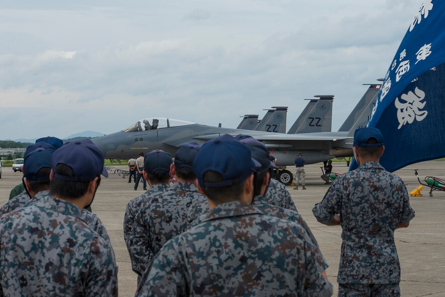 F-15 Eagles from the 44th Fighter Squadron park in front of Japan Air Self-Defense Force members at Tsuiki Air Base, Japan, Aug. 21, 2015. The 44th came to Tsuiki to participate in a two week long Aviation Training Relocation with Japan Air Self-Defense Force. (U.S. Air Force photo by Senior Airman Stephen G. Eigel)