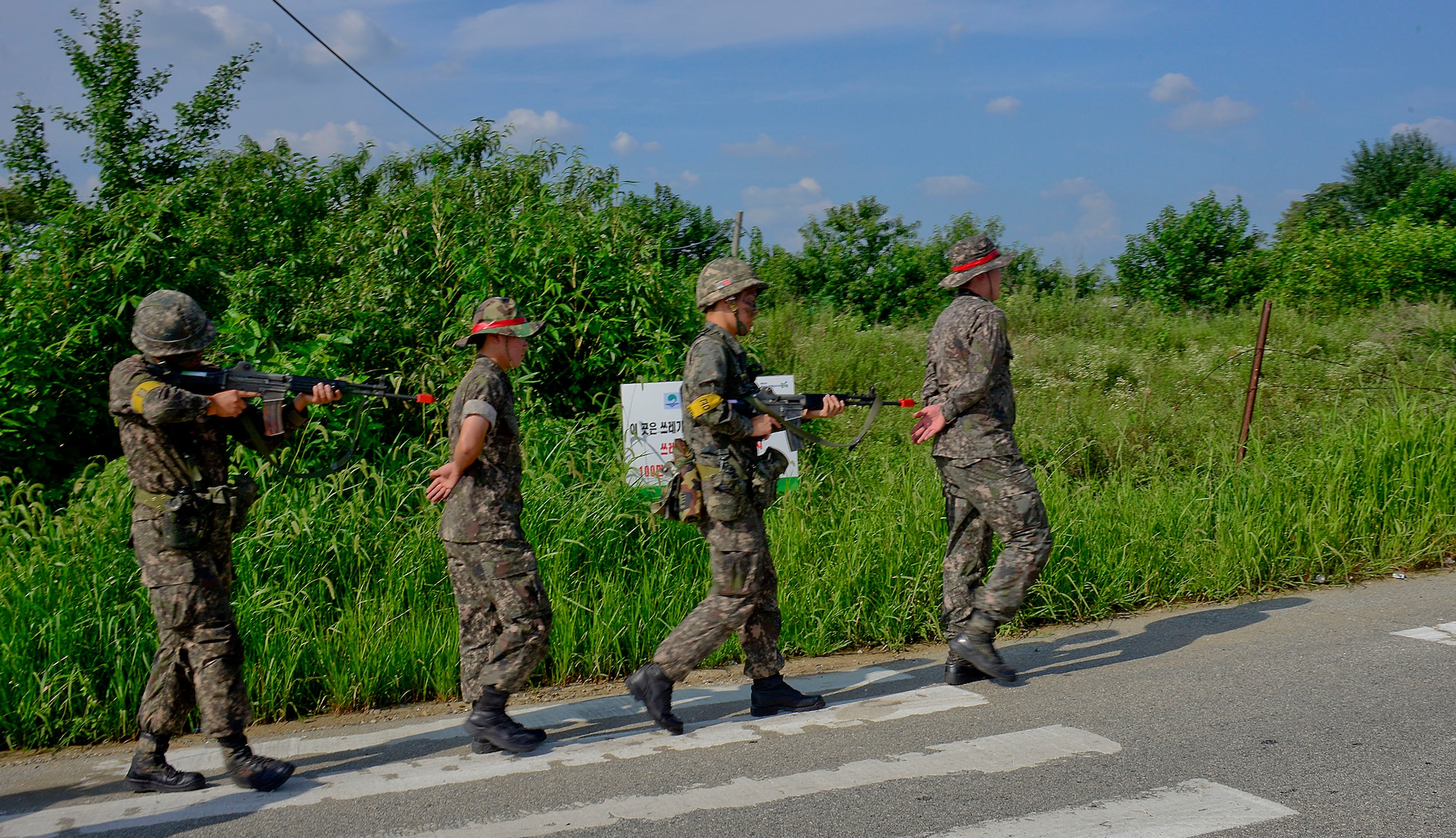 Republic of Korea army soldiers, 4th Battalion 169th Regiment, escort opposition forces during a joint mission as part of readiness exercise Beverly Midnight 15-03 in a training area outside Osan Air Base, ROK, Aug. 18, 2015. During the exercise, ROKA soldiers and 51st Security Forces Squadron defenders participated in scenarios potential to real-world wartime operational conditions. (U.S. Air Force photo/Senior Airman Kristin High)