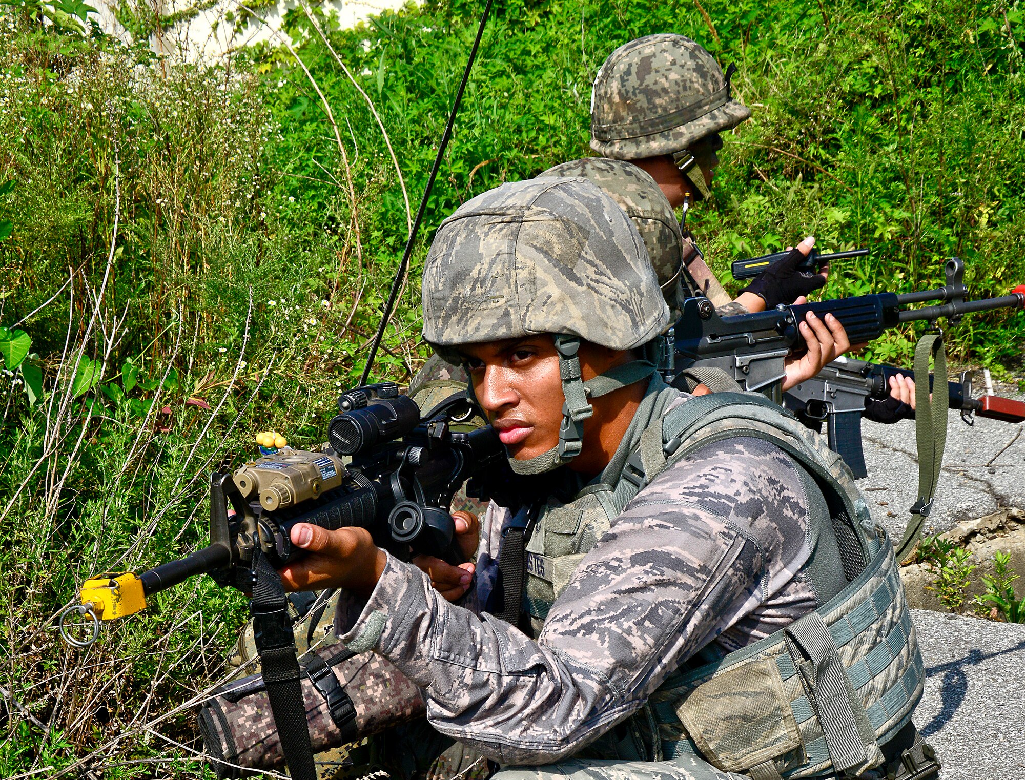Airman 1st Class Donte Estes, 51st Security Forces Squadron patrolman, provides cover during a joint mission as part of readiness exercise Beverly Midnight 15-03 in a training area outside Osan Air Base, Republic of Korea, Aug. 18, 2015. In a real-world operation, the 51st SFS would be responsible for securing the immediate area around the base to help keep the 51st Fighter Wing’s mission up and running. (U.S. Air Force photo/Senior Airman Kristin High)
