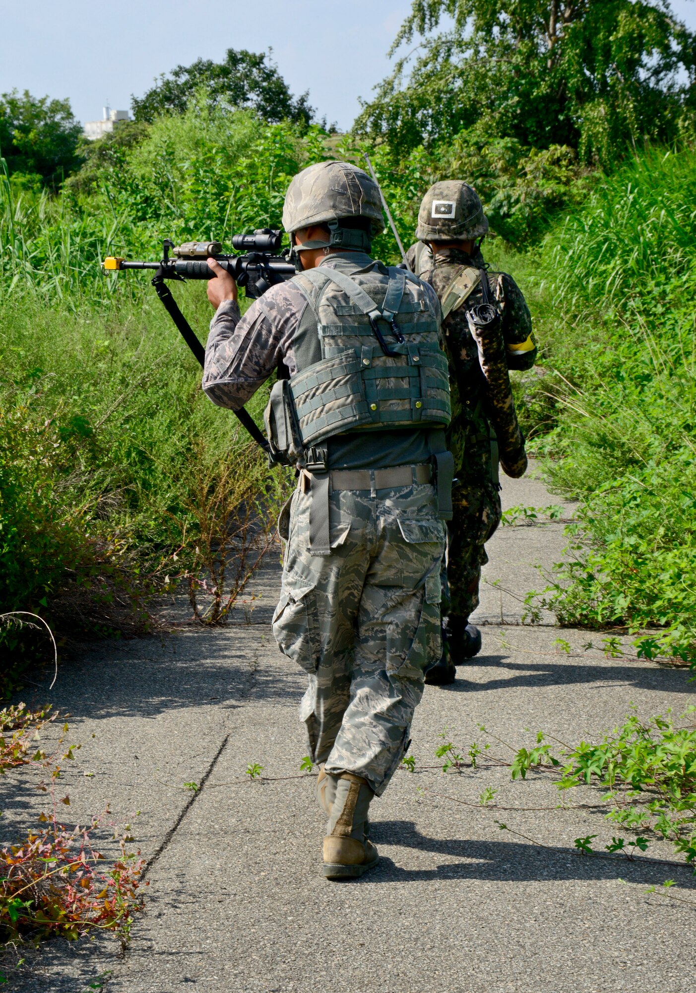 An airman from the 51st Security Forces Squadron and Republic of Korea army soldiers 4th Battalion 169th Regiment, search for opposition forces role players during a joint mission as part of readiness exercise Beverly Midnight 15-03 in a training area outside Osan Air Base, ROK, Aug. 18, 2015. In a real-world operation, the 51st SFS would be responsible for securing the immediate area around the base to help keep the 51st Fighter Wing’s mission up and running. (U.S. Air Force photo/Senior Airman Kristin High)