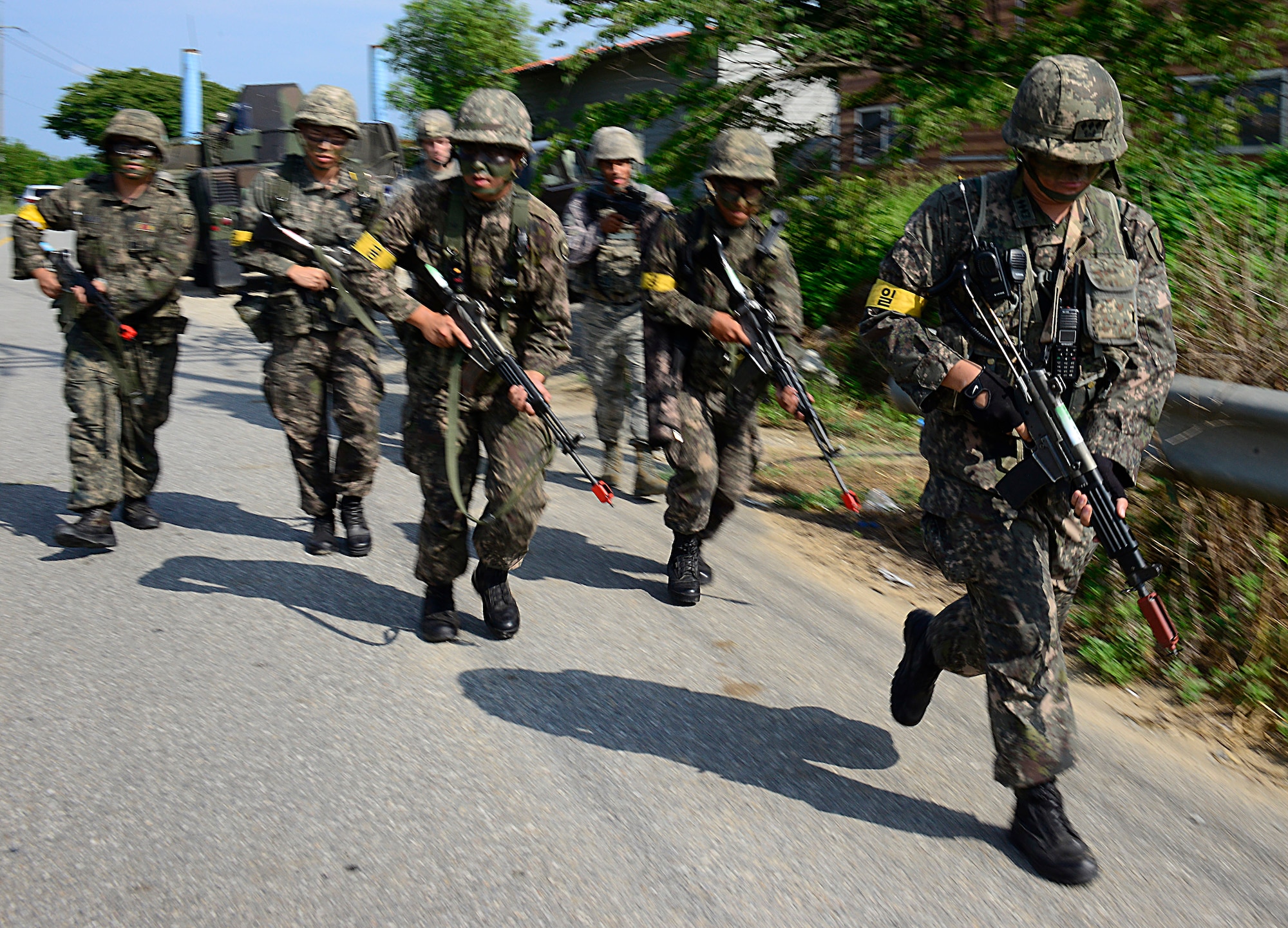 Defenders from the 51st Security Forces Squadron and Republic of Korea army soldiers from the 4th Battalion 169th Regiment, patrol during a joint mission as part of readiness exercise Beverly Midnight 15-03 in a training area outside Osan Air Base, ROK, Aug. 18, 2015. The 51st SFS and the ROKA trained together to enhance cooperation and ensure integration between the services is as smooth as possible during wartime contingency operations. (U.S. Air Force photo/Senior Airman Kristin High)