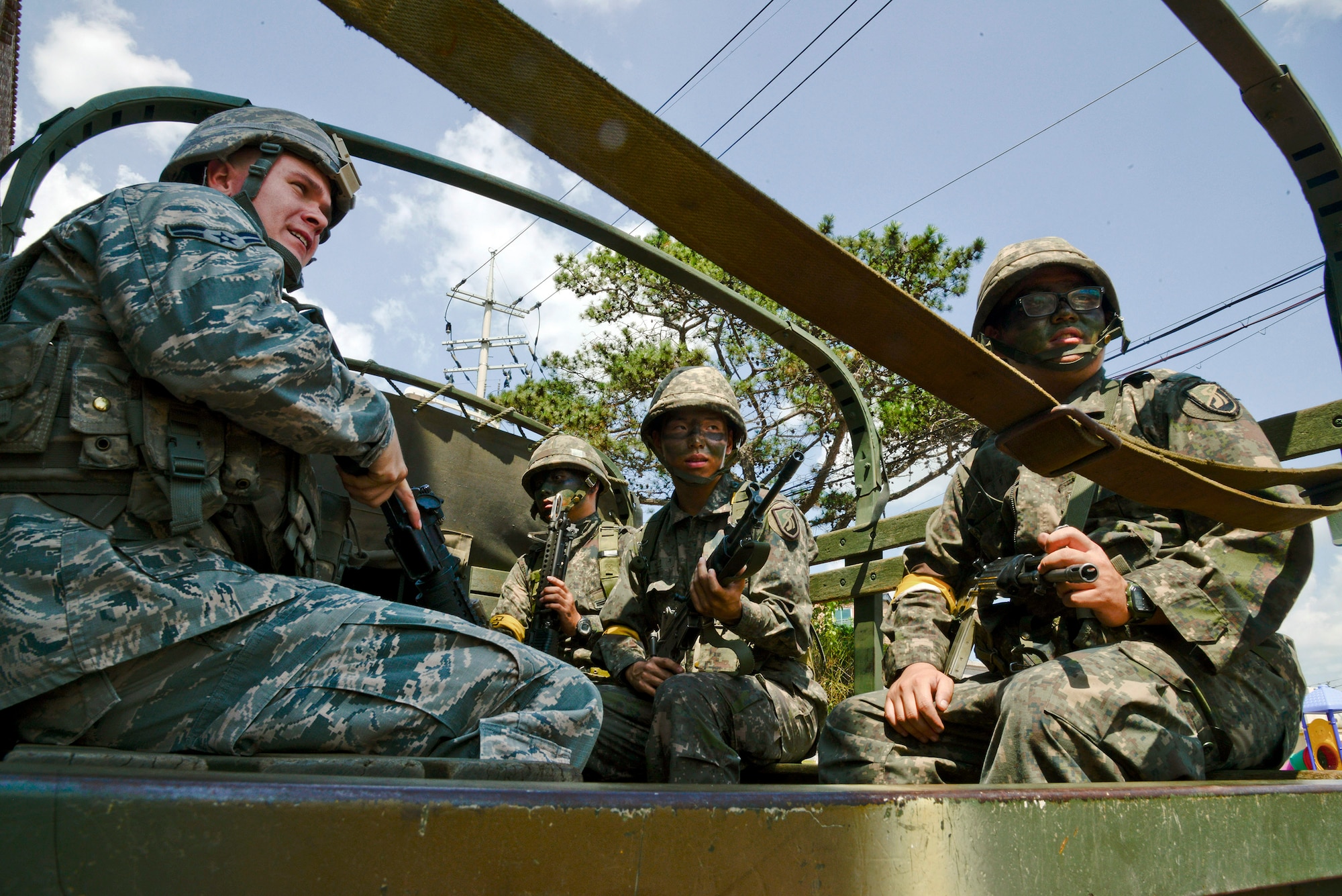 Defenders from the 51st Security Forces Squadron and Republic of Korea army soldiers from the 4th Battalion 169th Regiment, set out for a training area outside Osan Air Base, ROK, Aug. 19, 2015. The Airmen and ROK soldiers practiced joint missions during the readiness exercise Beverly Midnight 15-03. The joint exercise helped prepare Airmen and soldiers through various combat strategies in the event of enemy attack. (U.S. Air Force photo/Senior Airman Kristin High)