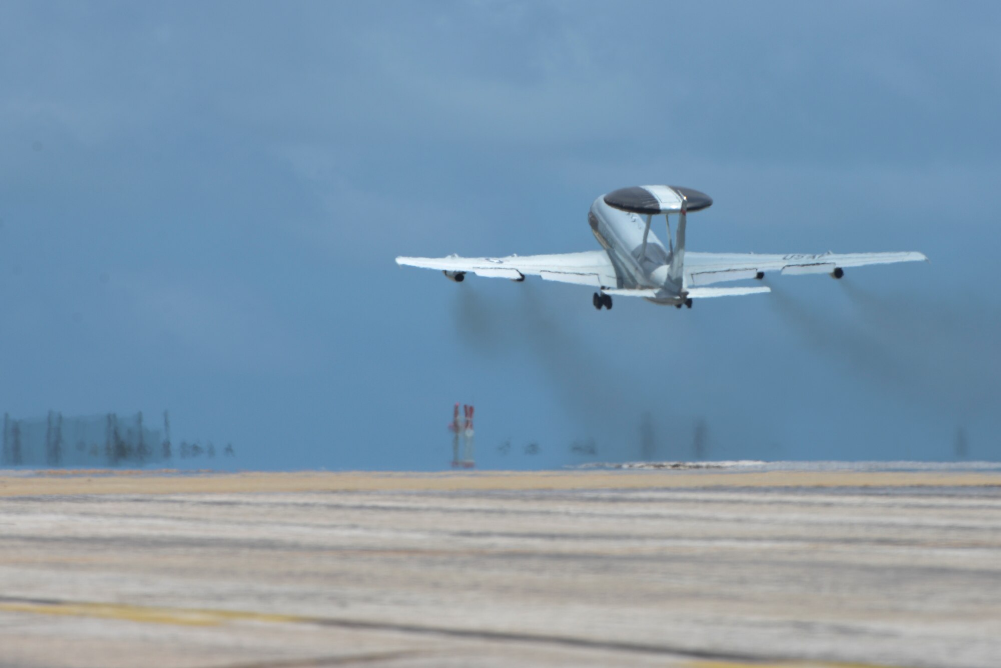 A U.S. Air Force E-3 Sentry Airborne Warning and Control System from the 961st Airborne Air Control Squadron takes off from Kadena Air Base, Japan, to avoid damaging winds and debris from an approaching typhoon Aug. 21, 2015. In standard preparation of typhoons like Typhoon Goni, which is slated to strike this weekend, numerous flying squadrons on the base relocate their aircraft to other bases in the region to protect them from the damaging winds and debris. (U.S. Air Force photo by Senior Airman Omari Bernard)