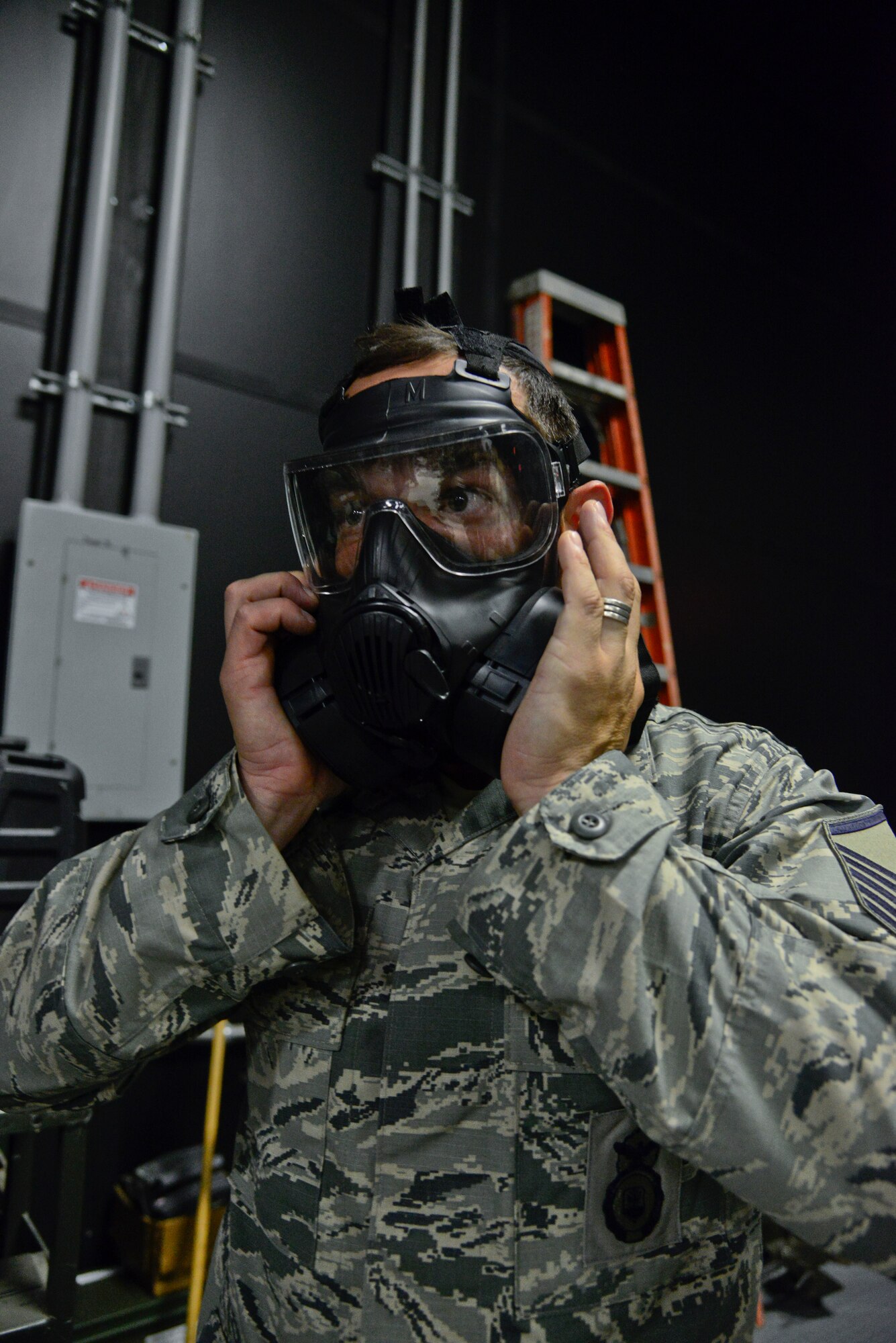 Master Sgt. Oscar Ochoa, 51st Security Forces Squadron flight chief, tests his M50 Joint Service General Purpose Field Mask in preparation for the readiness exercise, Beverly Midnight 15-03, on Osan Air Base, Republic of Korea, Aug. 18, 2015. The exercise is used to test Osan Airmen’s abilities during a heightened state of readiness while providing combat ready forces for close air support, air strike control, counter air, interdiction, theater airlift and communications in the defense of the ROK. The M50 mask is designed to provide continuous head-eye-respiratory, chemical, biological, and radiological particulates protection. (U.S. Air Force photo/Senior Airman Kristin High)