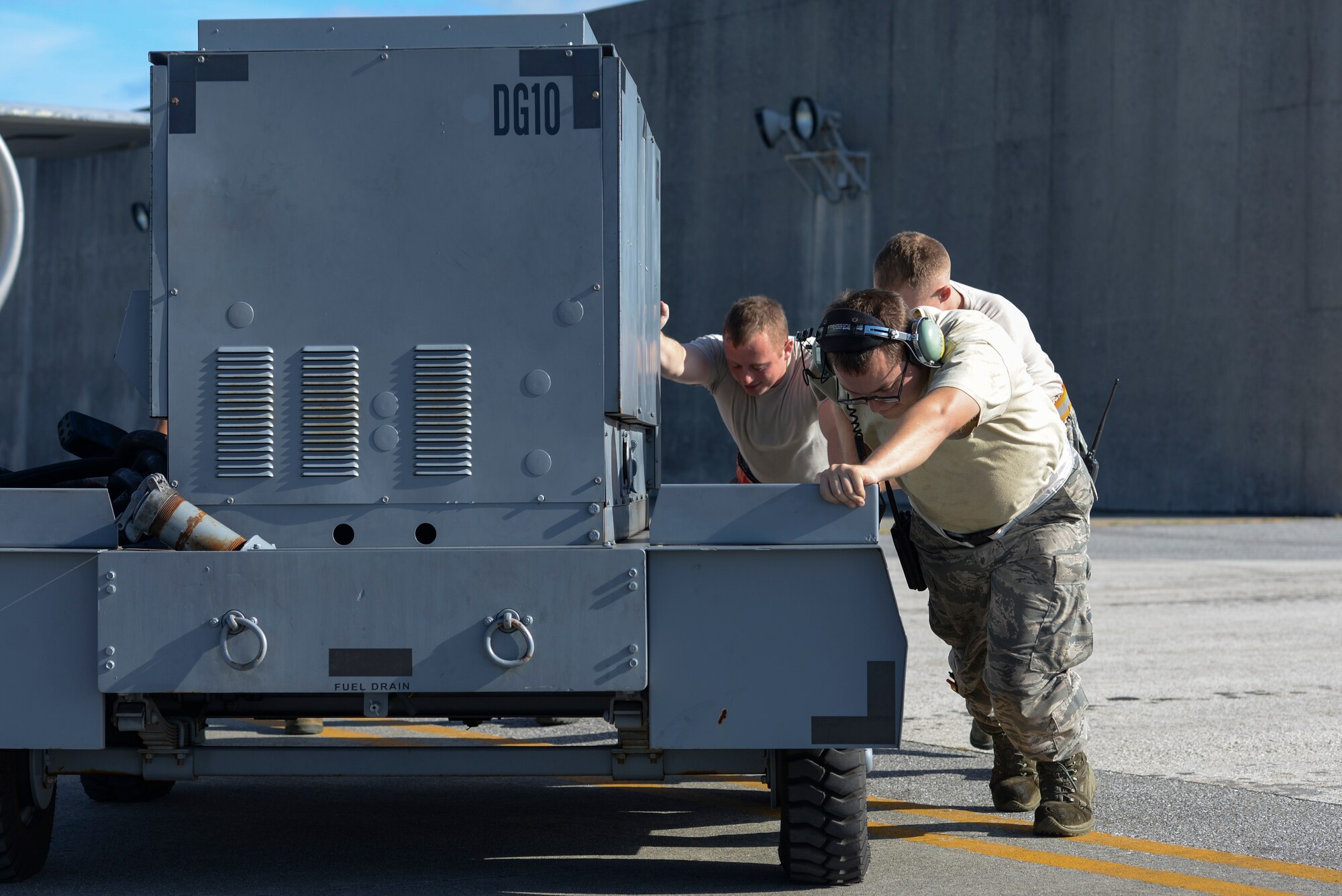 U.S. Air Force Airmen of the 909th Maintenance Squadron on Kadena Air Base, Japan, move a generator to perform the preflight checks for a KC-135 Stratotanker on Kadena Air Base, Japan, Aug. 8, 2015.  The KC-135 Stratotanker and other aircraft are temporarily relocating to other bases in the region to protect them from possible storm damage. (U.S. Air Force photo by Senior Airman Omari Bernard)