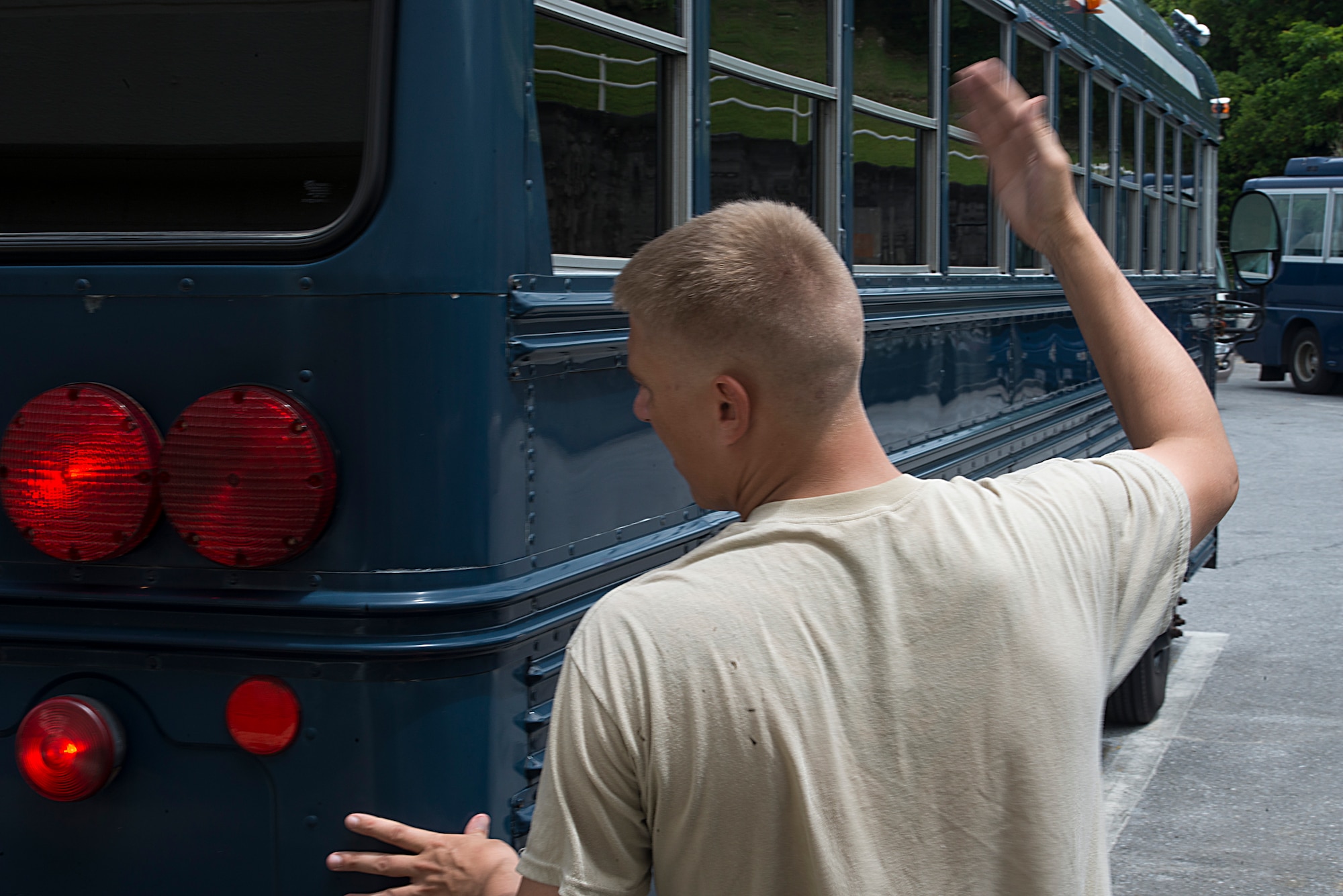 U.S. Air Force Staff Sgt. James Wilson, 18th Logistics Readiness Squadron vehicle operator, marshals a government vehicle into position in a safe zone on Kadena Air Base, Japan, to prevent damage during a typhoon Aug. 21, 2015. Each time a typhoon moves too close to Okinawa, units across Kadena follow a standardized procedure to ensure maximum safety and security for all equipment and assigned personnel. If it remains on course and at its current speed, Typhoon Goni is expected to hit Okinawa within the next few days. (U.S. Air Force photo by Staff Sgt. Maeson L. Elleman)