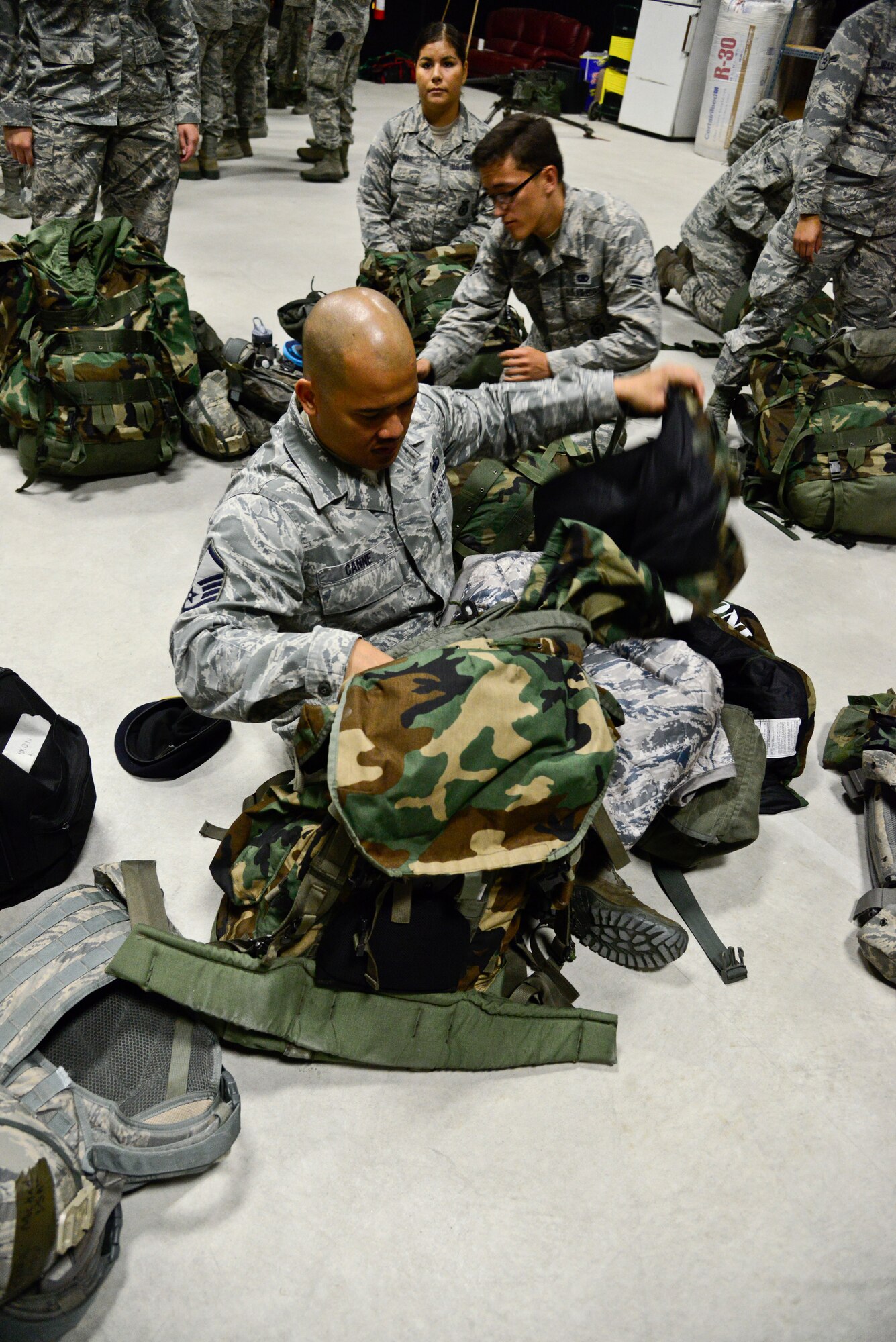 Master Sgt. Michael Canne, 51st Security Forces Squadron installation security section chief, inspects his chemical warfare bag for items on Osan Air Base, Republic of Korea, Aug. 18, 2015. In preparation for the upcoming readiness exercise, 51st SFS defenders inspected their chem-bags and were given refresher training to ensure proper techniques and safety were used. (U.S. Air Force photo/Senior Airman Kristin High)