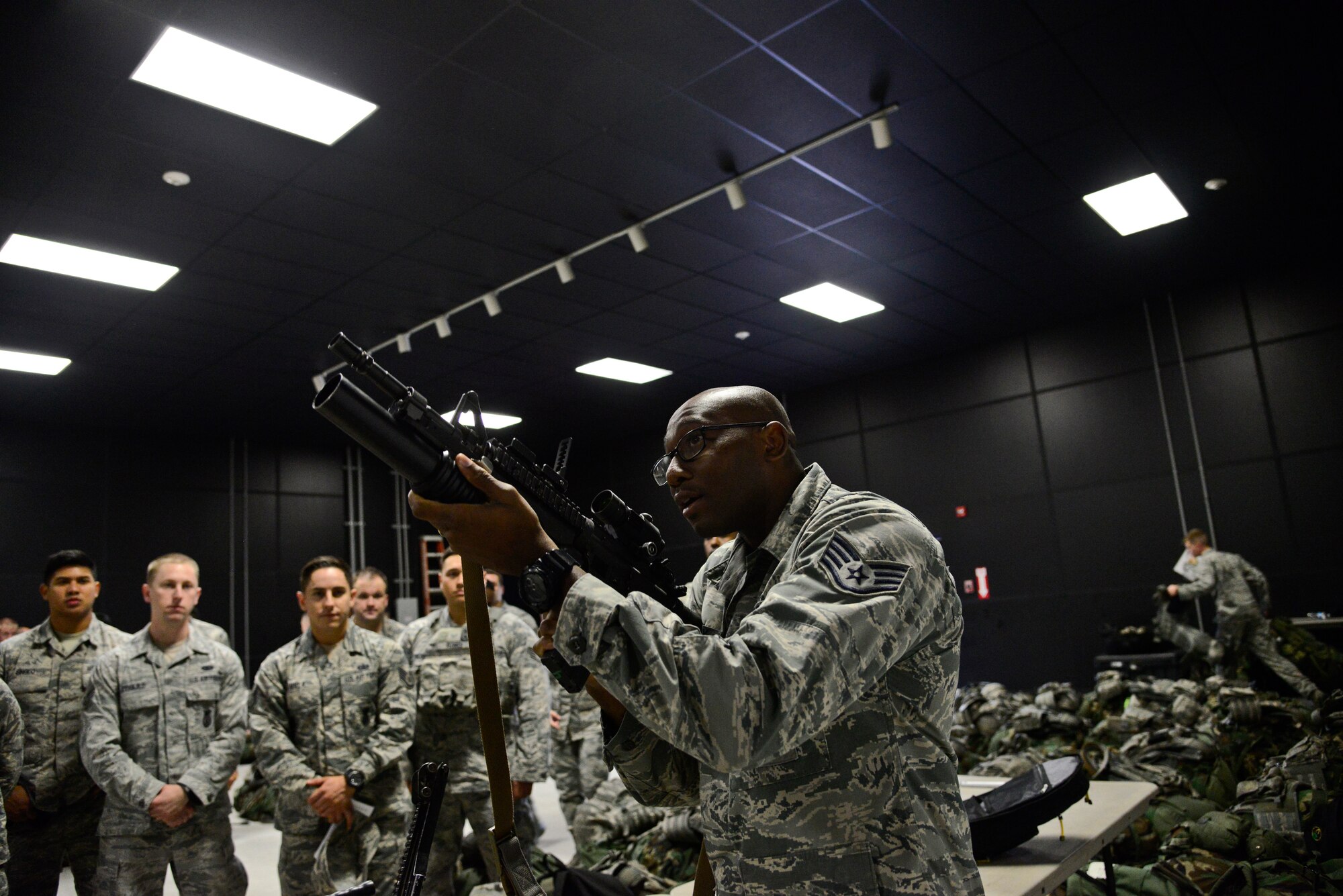 Staff Sgt. Terrance Bethany, 51st Security Forces Squadron combat arms instructor, demonstrates how to fire and reload an M-203 grenade launcher in preparation for the upcoming  readiness exercise, Beverly Midnight 15-03, on Osan Air Base, Republic of Korea, Aug. 18, 2015. The 51st SFS defenders trained on multiple firearms to ensure proper safety for the exercise and in the event of real-world wartime operations. (U.S. Air Force photo/Senior Airman Kristin High)