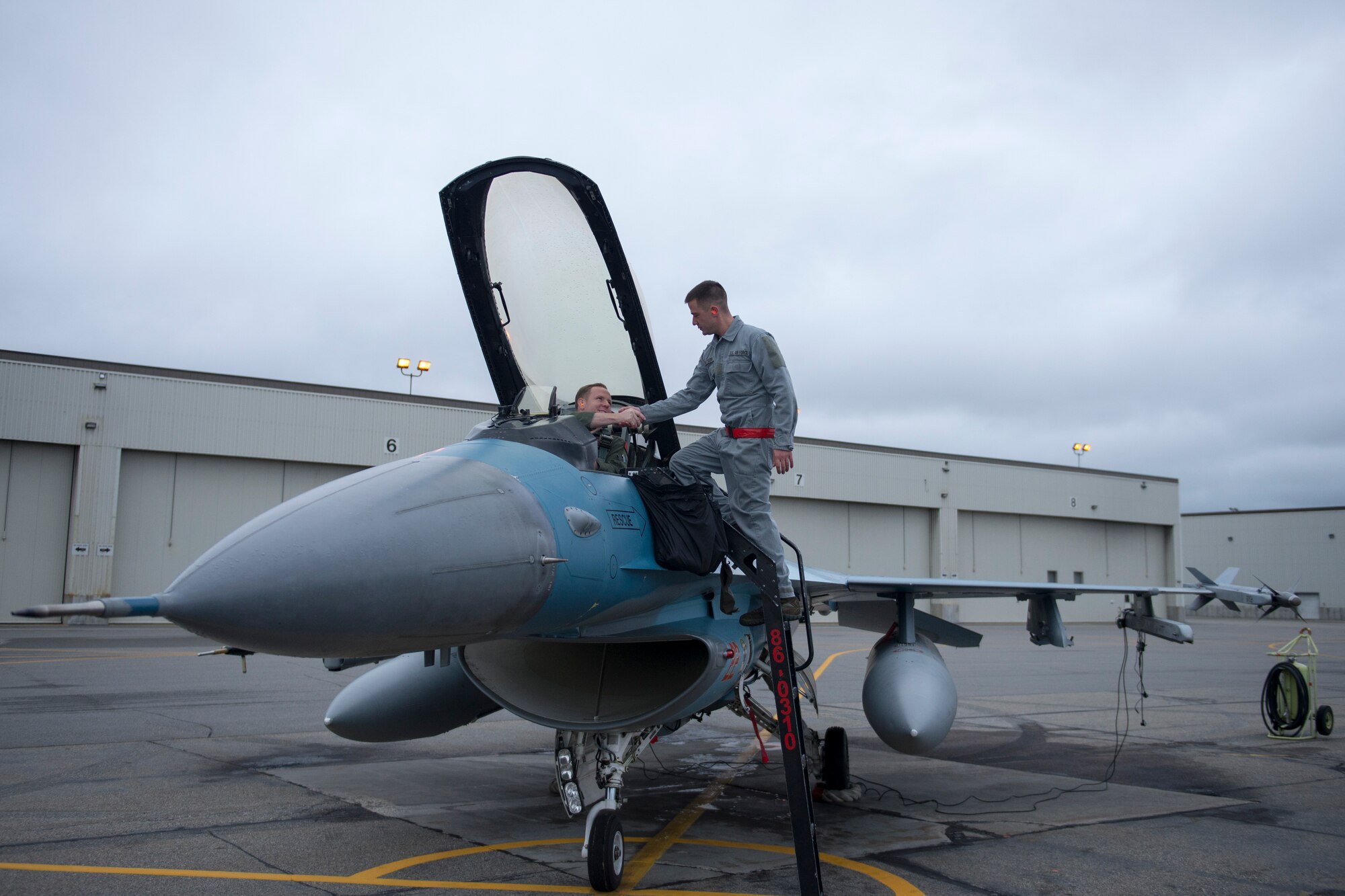 U.S. Air Force Capt. Jon Brown, an F-16 Fighting Falcon pilot, shakes the hand of Airman 1st Class Jason Watson, a 354th Aircraft Maintenance Squadron crew chief, Aug. 19, 2015, prior to the launch of a RED FLAG-Alaska (RF-A) 15-3 sortie from Eielson Air Force Base, Alaska. The support of the 354th Maintenance Group’s Airmen ensure the pilots of the 18th Aggressor Squadron can act as enemy “Red” forces to employ real-world tactics that require coalition “Blue” forces to adjust quickly, work together and overcome challenges during simulated combat sorties throughout RF-A. (U.S. Air Force photo by 1st Lt. Elias Zani/Released)