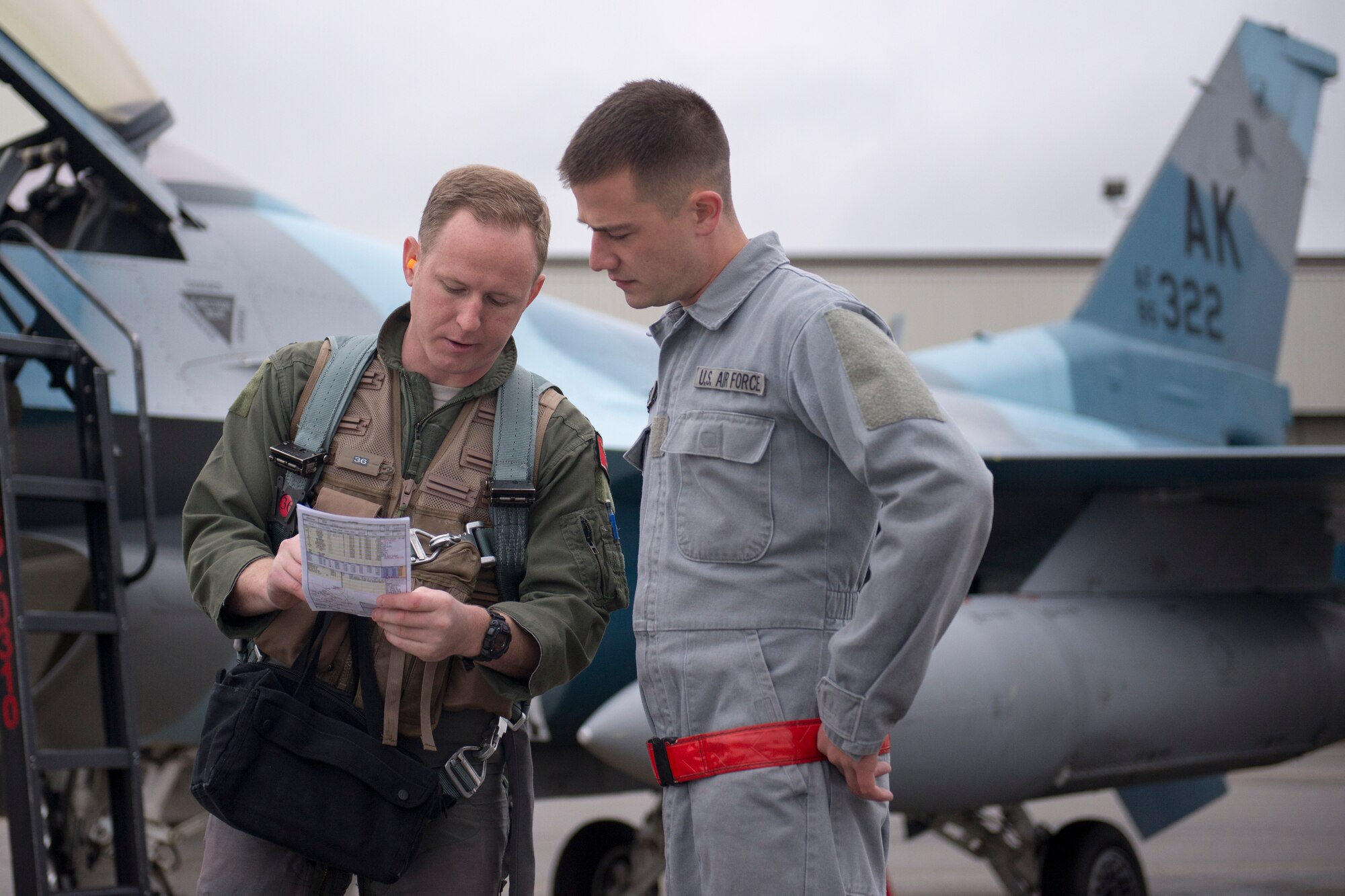 U.S. Air Force Capt. Jon Brown, an F-16 Fighting Falcon pilot, speaks with Airman 1st Class Jason Watson, a 354th Aircraft Maintenance Squadron crew chief, Aug. 19, 2015, prior to the launch of a RED FLAG-Alaska (RF-A) 15-3 sortie from Eielson Air Force Base, Alaska. RF-A is a Pacific Air Forces commander-directed field training exercise for U.S. and partner nation forces, providing combined offensive counter-air, interdiction, close air support and large force employment training in a simulated combat environment. (U.S. Air Force photo by 1st Lt. Elias Zani/Released)