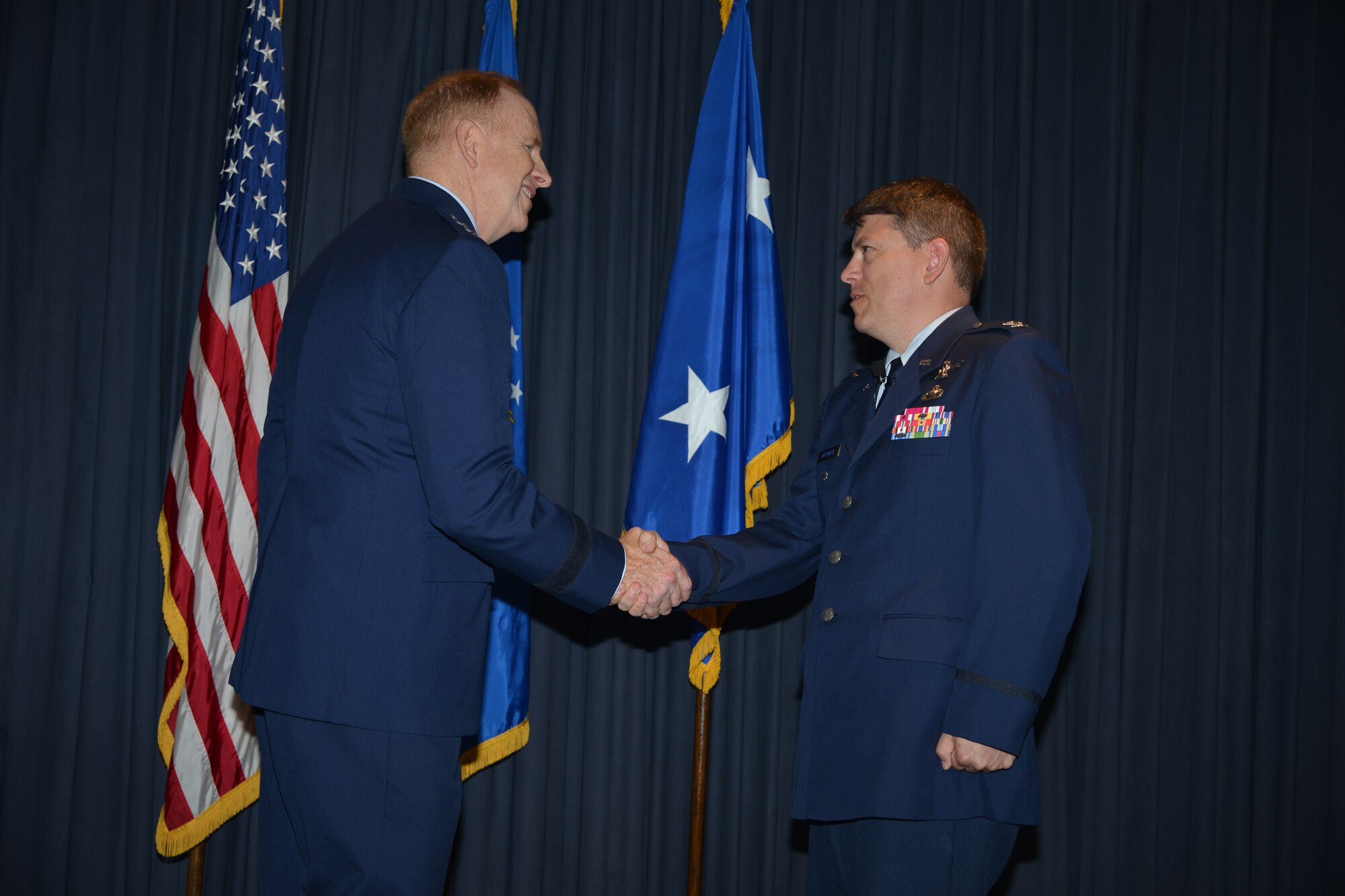 Presiding official Maj. Gen. Robert McMurry, Space and Missile Systems Center vice commander congratulates Col. John S.R. Anttonen as he accepts command as ingoing  director of the Advanced Systems and Development Directorate and commander of SMC’s Detachment 1 at Kirtland in an assumption of command ceremony held later in the day (U.S. Air Force courtesy photo) 