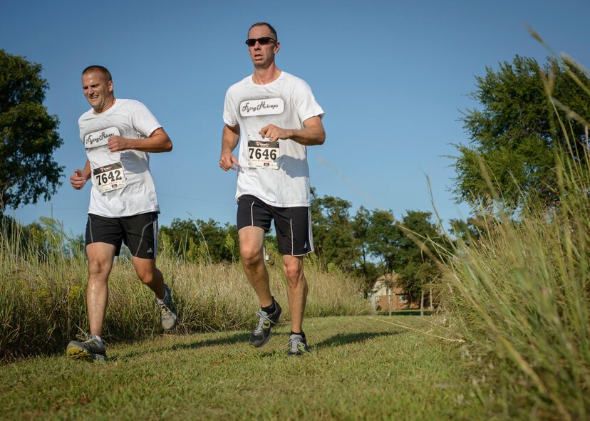 Senior Master Sgt. Brian Pilatzke  (left) and Lt. Col. J.J. Loschinskey dig deep during the final stretch of a community cross country meet in Enid, Oklahoma, Aug. 20. Enid High School sanctioned a first-ever military division of their annual cross country invitational meet at Northern Oklahoma College. (U.S. Air Force photo by David Poe) 