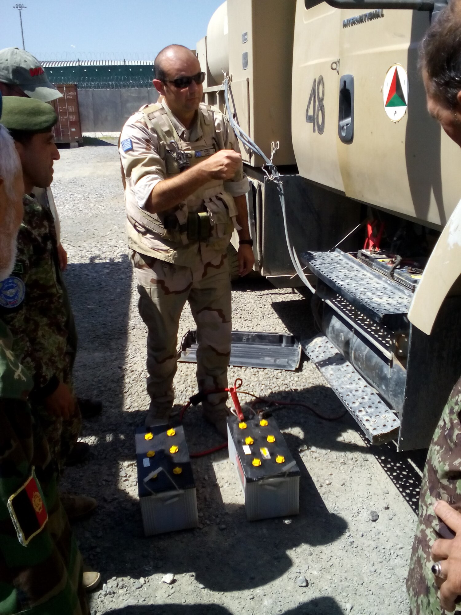 Greek Warrant Officer Ioannidis Emmanouil, a 16-year vehicle mechanic quality control inspector and Train, Advise, Assist Command-Air (TAAC-Air) certified trainer, teaches Afghan National Army and Afghan Air Force vehicle maintainers at Kabul Air Wing Aug. 6, 2015.  TAAC-Air advisors and contractors work to refine AAF logistics, reduce new acquisitions and programs, and create a sustainable and capable air force to support the Afghan National Security Forces in the coming years. The Vehicle Maintenance Training Program (VMTP) is one focus area to acquire coalition expertise to provide meaningful instruction on specialized equipment and contractor support to the AAF. They began training June 27, 2015. (U.S. Air Force photo by Capt. Eydie Sakura/Released)