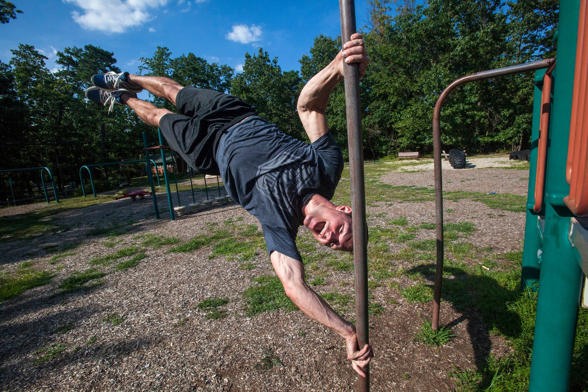 Tech. Sgt. Justin B. Gielski performs his human flag pose while training to compete on the TV show “American Ninja Warrior” at a playground near his home in Medford, N.J., Aug. 21, 2015. Gielski placed fifth in the all-military city final on the TV show and advanced to the finals in Las Vegas. Gielski is a loadmaster with the 150th Special Operations Squadron, 108th Wing, New Jersey Air National Guard, located at Joint Base McGuire-Dix-Lakehurst, N.J. (U.S. Air National Guard photo by Master Sgt. Mark C. Olsen/Released)