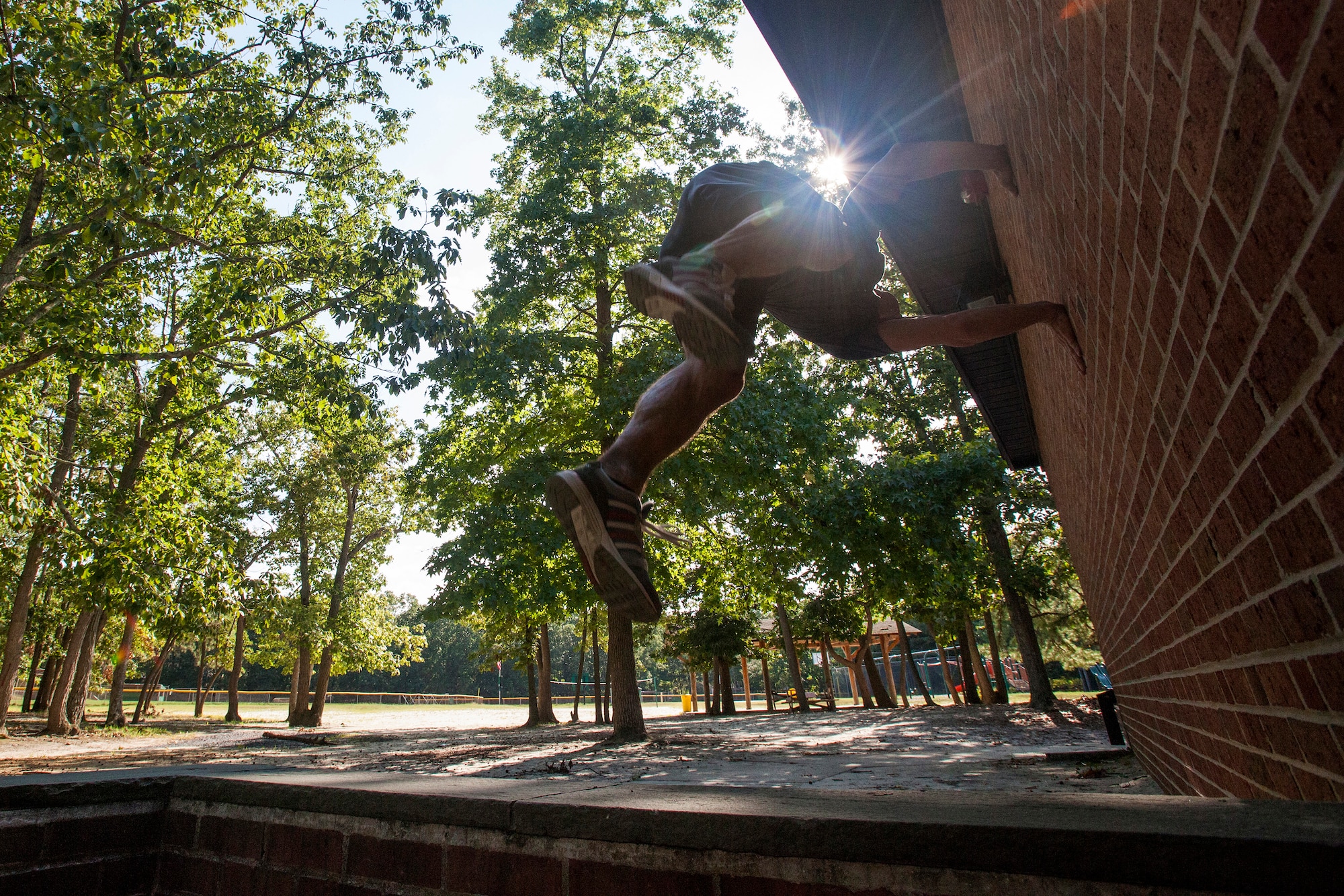 Tech. Sgt. Justin B. Gielski performs a flip on a wall while training to compete on the TV show “American Ninja Warrior” at a playground near his home in Medford, N.J., Aug. 21, 2015. Gielski placed fifth in the all-military city final on the TV show and advanced to the finals in Las Vegas. Gielski is a loadmaster with the 150th Special Operations Squadron, 108th Wing, New Jersey Air National Guard, located at Joint Base McGuire-Dix-Lakehurst, N.J. (U.S. Air National Guard photo by Master Sgt. Mark C. Olsen/Released)