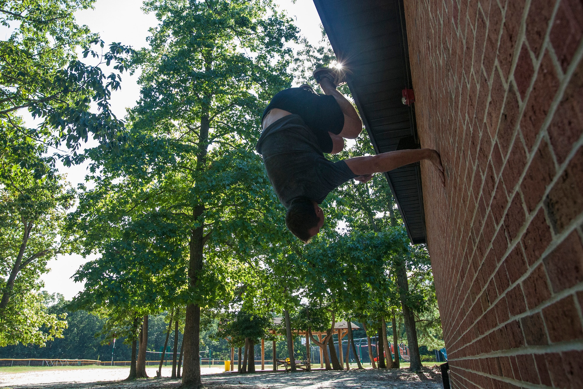 Tech. Sgt. Justin B. Gielski performs a flip on a wall while training to compete on the TV show “American Ninja Warrior” at a playground near his home in Medford, N.J., Aug. 21, 2015. Gielski placed fifth in the all-military city final on the TV show and advanced to the finals in Las Vegas. Gielski is a loadmaster with the 150th Special Operations Squadron, 108th Wing, New Jersey Air National Guard, located at Joint Base McGuire-Dix-Lakehurst, N.J. (U.S. Air National Guard photo by Master Sgt. Mark C. Olsen/Released)