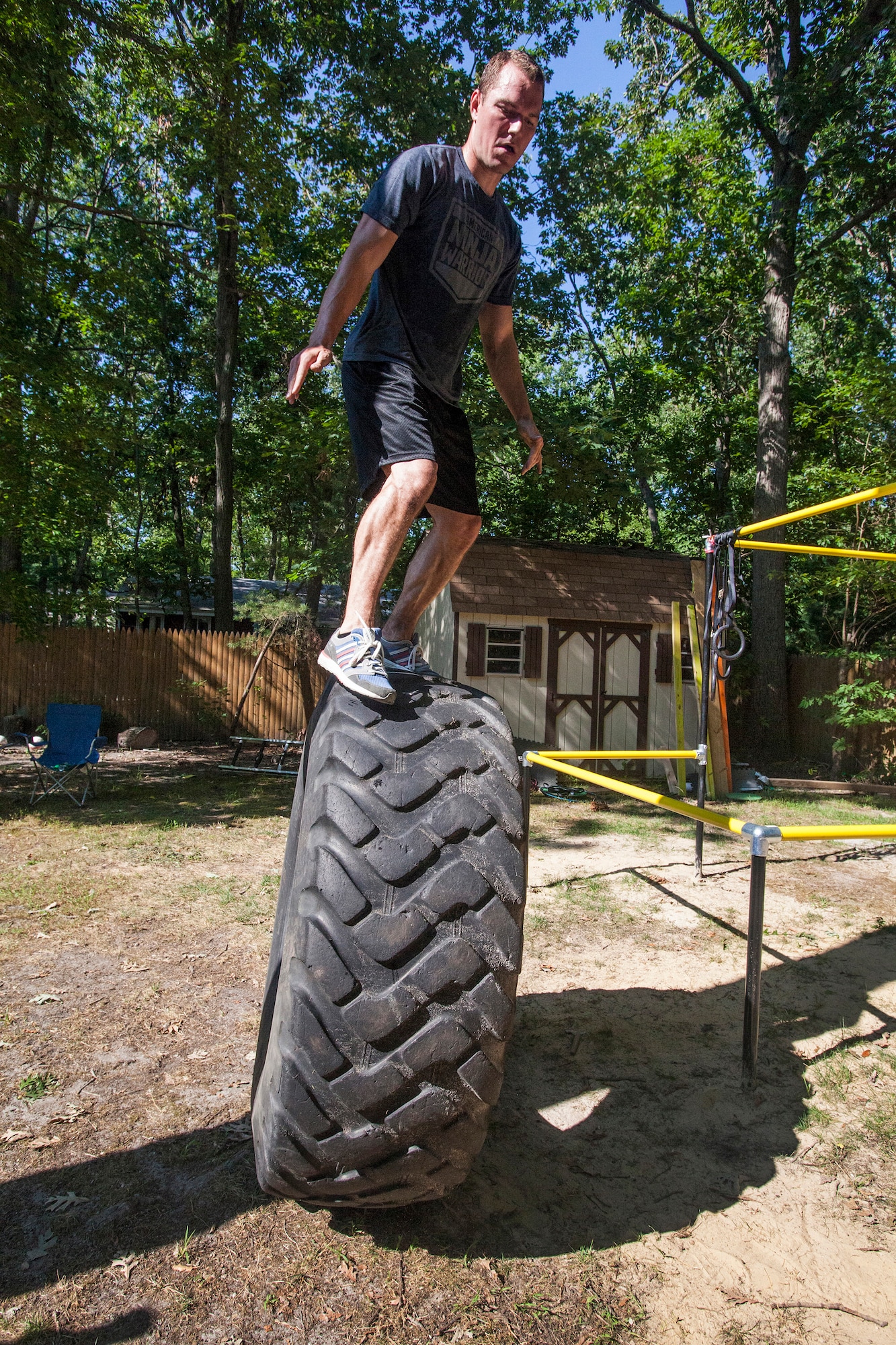 Tech. Sgt. Justin B. Gielski balances on a tire while training to compete on the TV show “American Ninja Warrior” in the backyard of his home in Medford, N.J., Aug. 21, 2015. Gielski placed fifth in the all-military city final on the TV show and advanced to the finals in Las Vegas. Gielski is a loadmaster with the 150th Special Operations Squadron, 108th Wing, New Jersey Air National Guard, located at Joint Base McGuire-Dix-Lakehurst, N.J. (U.S. Air National Guard photo by Master Sgt. Mark C. Olsen/Released)