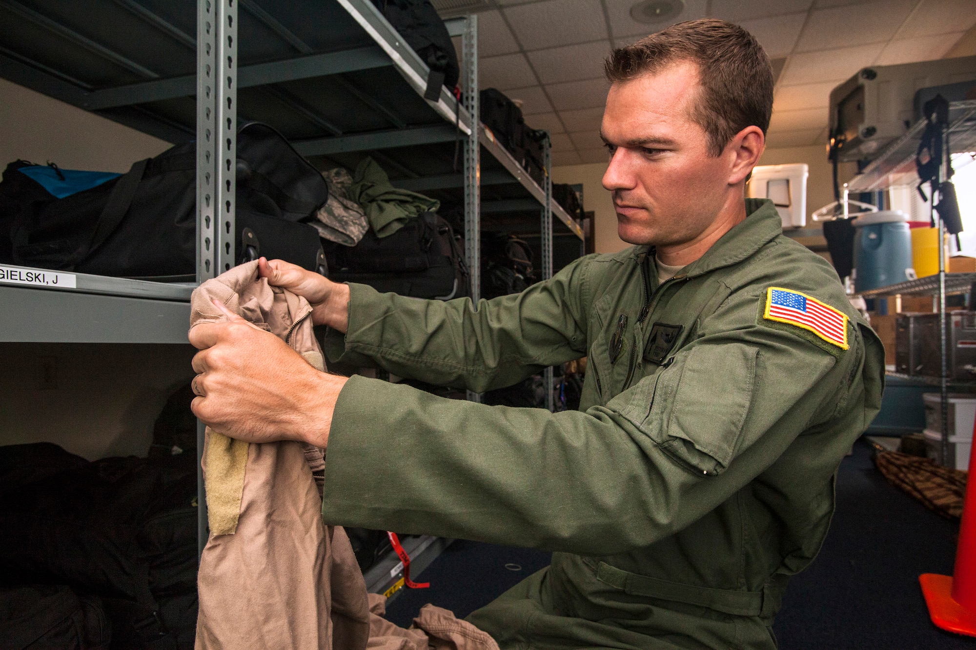 Tech. Sgt. Justin B. Gielski, a loadmaster with the 150th Special Operations Squadron, 108th Wing, New Jersey Air National Guard, checks his deployment bag at Joint Base McGuire-Dix-Lakehurst, N.J., Aug. 19, 2015. Gielski placed fifth in the all-military city final on the TV show “American Ninja Warrior” and advanced to the finals in Las Vegas. (U.S. Air National Guard photo by Master Sgt. Mark C. Olsen/Released)