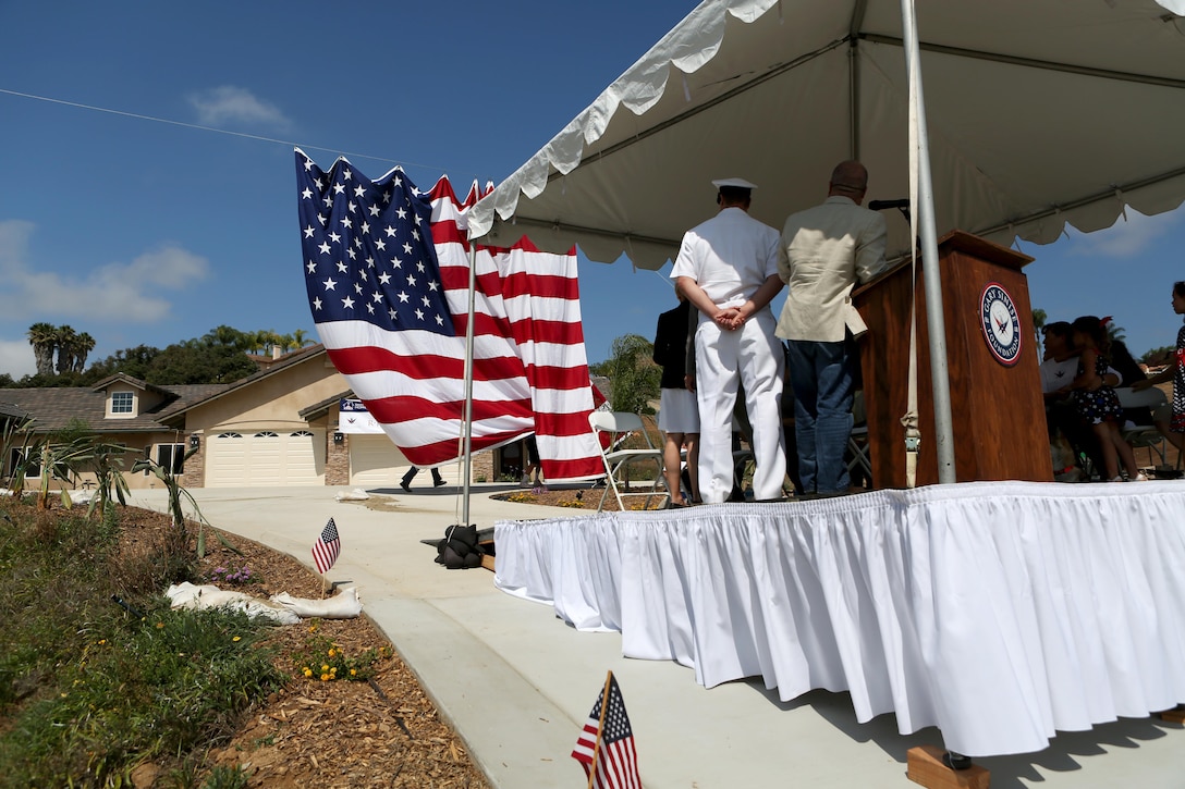 Members of The Gary Sinise foundation unveil a new home built and dedicated to retired Staff Sgt. Jason Ross and his family through the foundation’s Restoring Independence Supporting Empowerment program in Fallbrook, California, August 21, 2015. Ross was injured by an improvised explosive device in Afghanistan in 2011 while serving as an explosive ordnance disposal technician and lost both of his legs as a result. The new home has smart technology that will significantly reduce the difficulty of everyday tasks for Ross and allow him and his family to live more comfortably.