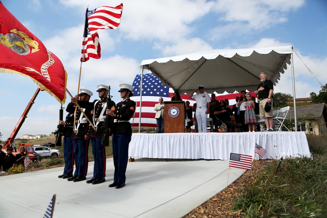 Marines from 1st Intelligence Battalion, 1st Marine Logistics Group present the national and Marine Corps colors during a ceremony where The Gary Sinise Foundation presented and newly built Smart home to retired Staff Sgt. Jason Ross and his family in Fallbrook, California, August 21, 2015. Ross stepped was injured by an improvised explosive device in Afghanistan in 2011 while serving as an explosive ordnance disposal technician and lost both of his legs as a result. The new home has smart technology that will significantly reduce the difficulty of everyday tasks for Ross and allow him and his family to live more comfortably.
