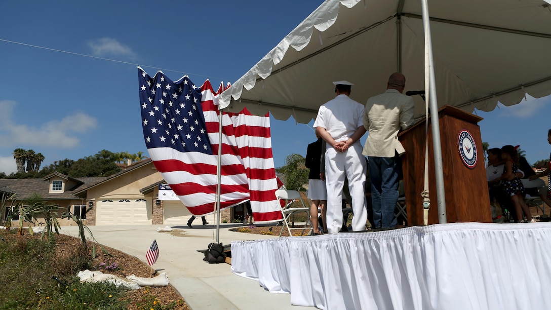 Members of The Gary Sinise foundation unveil a new home built and dedicated to retired Staff Sgt. Jason Ross and his family through the foundation’s Restoring Independence Supporting Empowerment program in Fallbrook, California, August 21, 2015. Ross was injured by an improvised explosive device in Afghanistan in 2011 while serving as an explosive ordnance disposal technician and lost both of his legs as a result. The new home has smart technology that will significantly reduce the difficulty of everyday tasks for Ross and allow him and his family to live more comfortably.