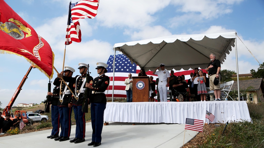 Marines from 1st Intelligence Battalion, 1st Marine Logistics Group present the national and Marine Corps colors during a ceremony where The Gary Sinise Foundation presented and newly built Smart home to retired Staff Sgt. Jason Ross and his family in Fallbrook, California, August 21, 2015. Ross stepped was injured by an improvised explosive device in Afghanistan in 2011 while serving as an explosive ordnance disposal technician and lost both of his legs as a result. The new home has smart technology that will significantly reduce the difficulty of everyday tasks for Ross and allow him and his family to live more comfortably.