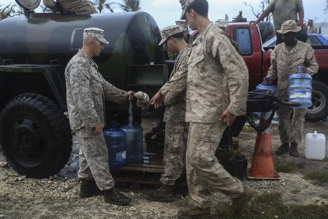 U.S. Marines fill up water jugs for locals as part of a typhoon relief mission in Saipan Aug. 15, 2015. The Marines with Echo Company, Battalion Landing Team 2nd Battalion, 5th Marines, 31st Marine Expeditionary Unit, and Combat Logistics Battalion 31, 31st MEU, assisted the locals of Saipan by producing and distributing potable water. The Marines and sailors of the 31st MEU were conducting training near the Mariana Islands when they were redirected to Saipan after the island was struck by Typhoon Soudelor Aug. 2-3. (U.S. Marine Corps photo by Cpl. Ryan C. Mains/Released)