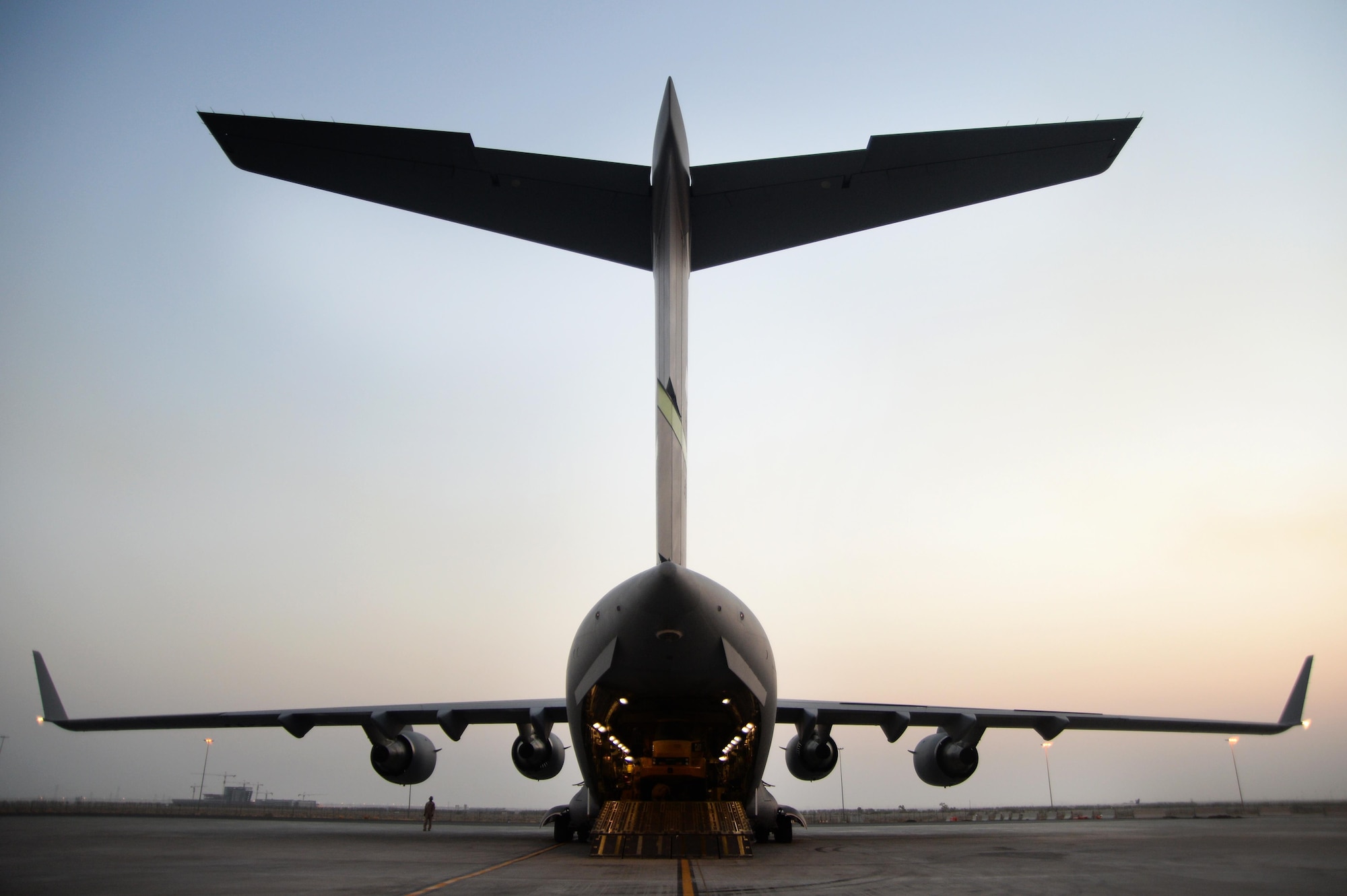 U.S. Air Force members prepare to unload cargo from a C-17 Globemaster III in support of Operation Inherent Resolve in Kuwait, August 14, 2015. OIR is the military intervention against Daesh. (U.S. Air Force photo by Staff Sgt. Sandra Welch)   
