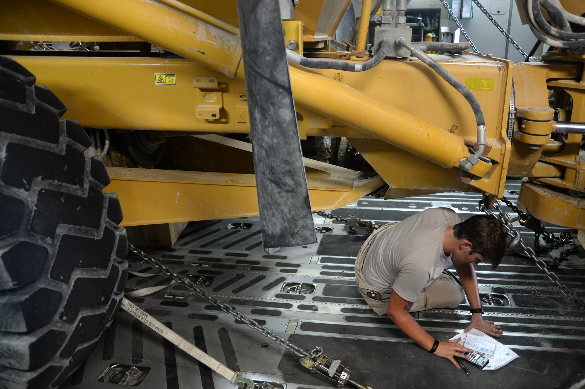 U.S. Air Force Senior Airman Rebecca, 816th Expeditionary Airlift Squadron loadmaster, performs pre-flight calculations on board a C-17 Globemaster III in support of Operation Inherent Resolve at Al Udeid Air Base, Qatar, August 14, 2015. OIR is the military intervention against Daesh. (U.S. Air Force photo by Staff Sgt. Sandra Welch)   