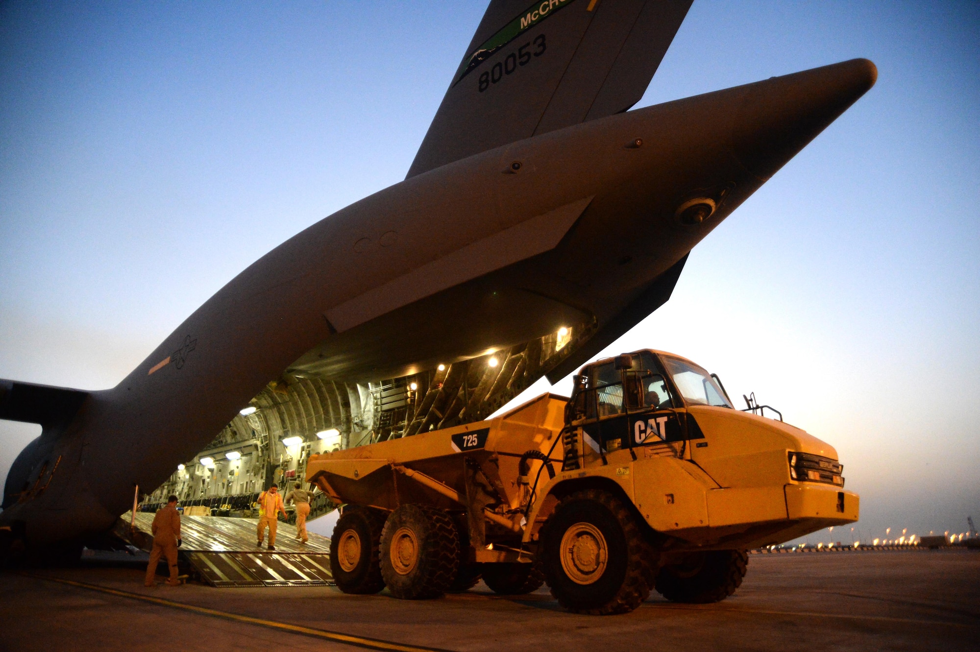 U.S. Air Force members unload a heavy operations vehicle from a C-17 Globemaster III in support of Operation Inherent Resolve in Kuwait, August 14, 2015. OIR is the military intervention against Daesh. (U.S. Air Force photo by Staff Sgt. Sandra Welch)   