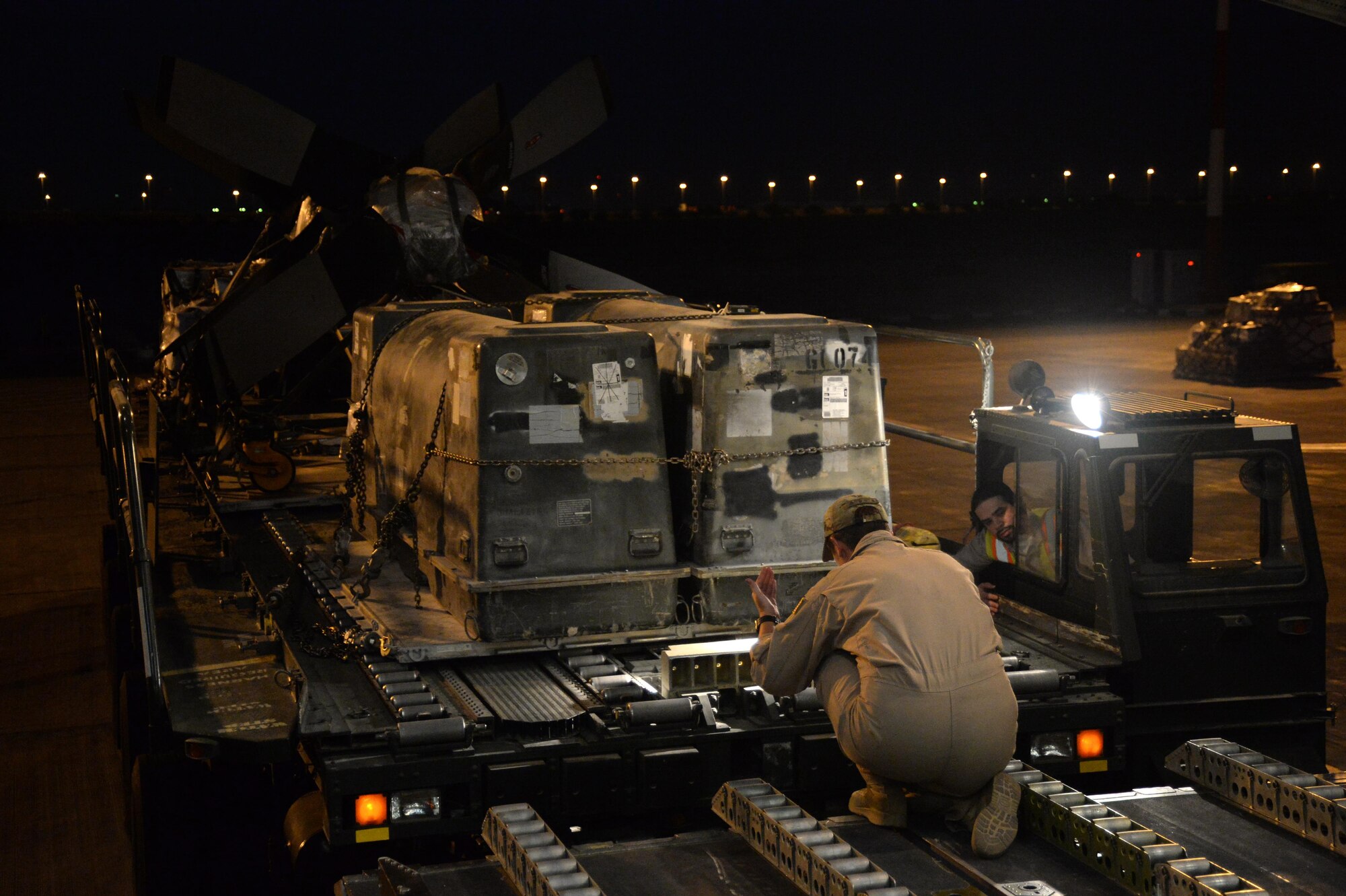 U.S. Air Force Senior Airman Rebecca, 816th Expeditionary Airlift Squadron loadmaster, guides a pay-loader to load cargo on board a C-17 Globemaster III in support of Operation Inherent Resolve in Kuwait, August 14, 2015. OIR is the military intervention against Daesh. (U.S. Air Force photo by Staff Sgt. Sandra Welch)   