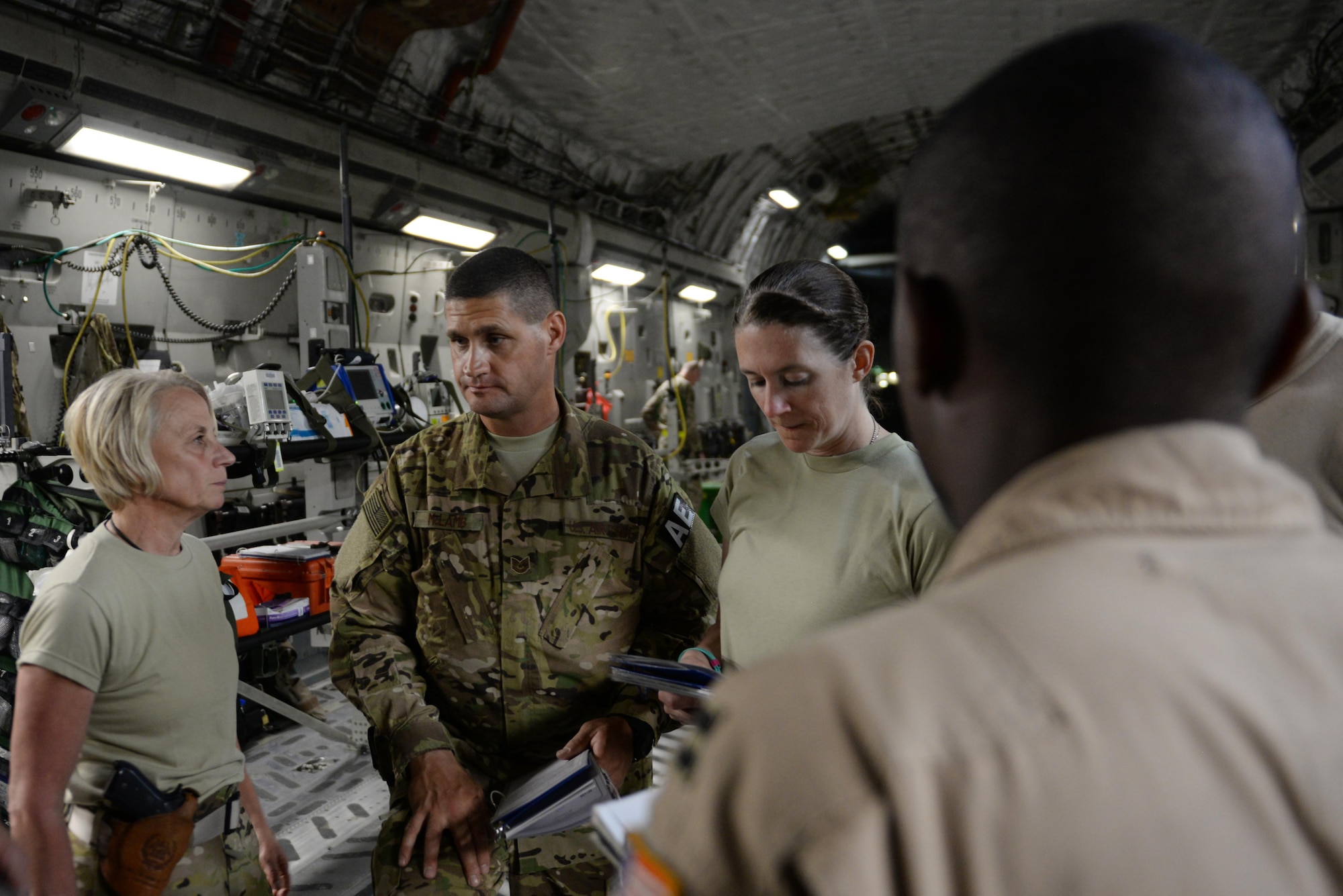 U.S. Air Force Tech. Sgt. Russell “Rusty” McLamb, center, 455th Expeditionary Aeromedical Evacuation Squadron technician deployed from the North Carolina Air National Guard’s 156th Aeromedical Evacuation Squadron, participates in a crew brief on a C-17 Globemaster III aircraft on the flight line at Bagram Airfield, Afghanistan, Aug. 8, 2015, prior to an aeromedical evacuation mission to Germany. McLamb is part of the 455th EAES, which is responsible for evacuating the sick and wounded from Central Command to higher echelons of medical care. (U.S. Air Force photo by Maj. Tony Wickman/Released)