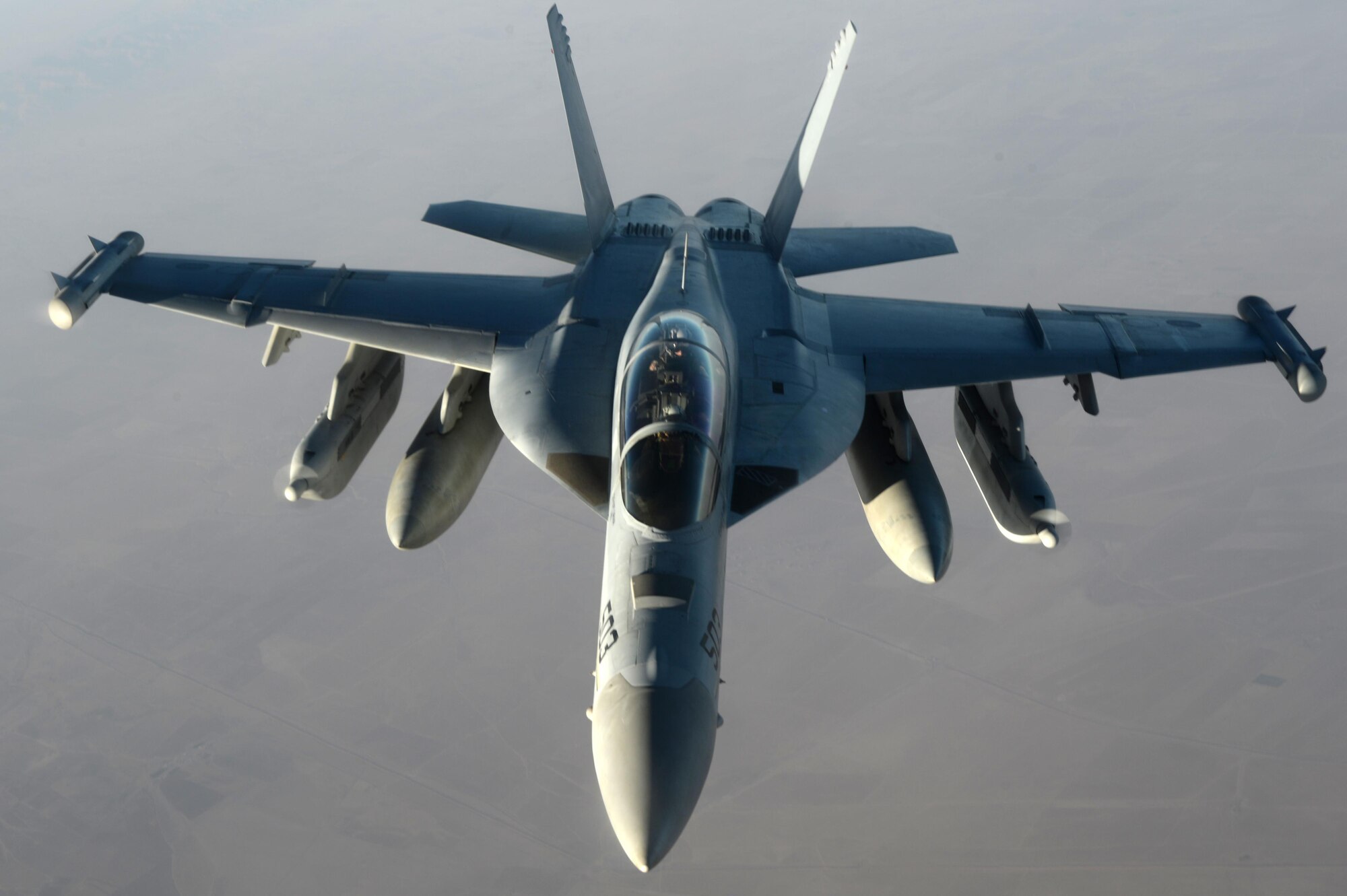 A U.S. Navy EA-18G Growler waits to be refueled by a U.S. Air Force KC-135 Stratotanker over Southwest Asia in support of Operation Inherent Resolve, Aug. 20, 2015. OIR is the military intervention against Daesh. (U.S. Air Force photo by Staff Sgt. Sandra Welch)