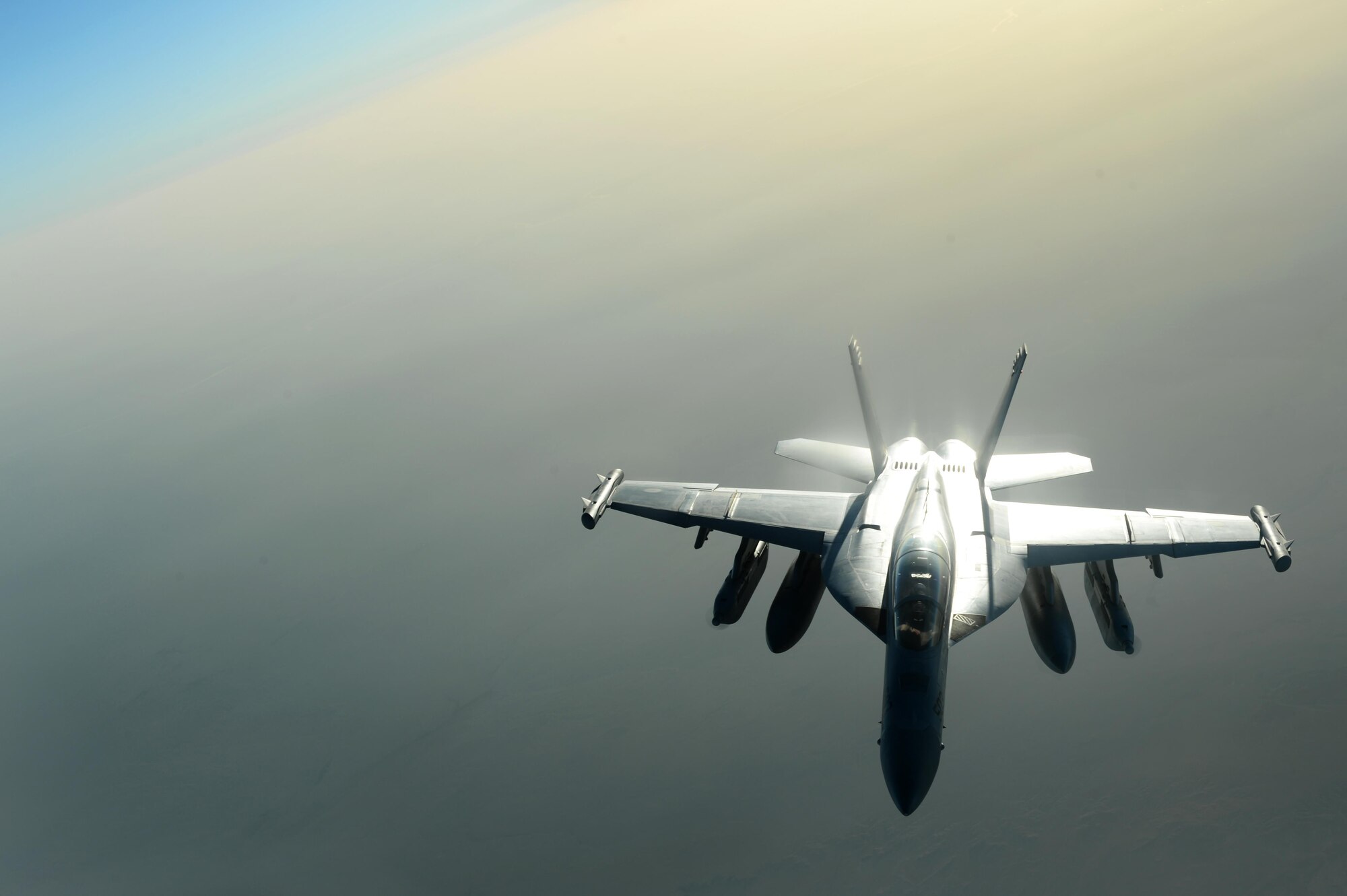 A U.S. Navy EA-18G Growler waits to be refueled by a U.S. Air Force KC-135 Stratotanker over Southwest Asia in support of Operation Inherent Resolve, Aug. 20, 2015. OIR is the military intervention against Daesh. (U.S. Air Force photo by Staff Sgt. Sandra Welch)