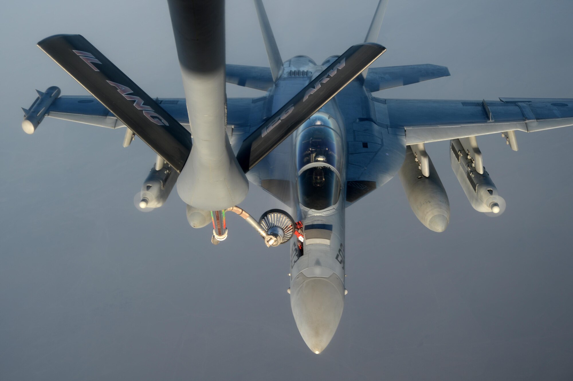 A U.S. KC-135 Stratotanker refuels a U.S. Navy EA-18G Growler over Southwest Asia in support of Operation Inherent Resolve, Aug. 20, 2015. OIR is the military intervention against Daesh. (U.S. Air Force photo by Staff Sgt. Sandra Welch)