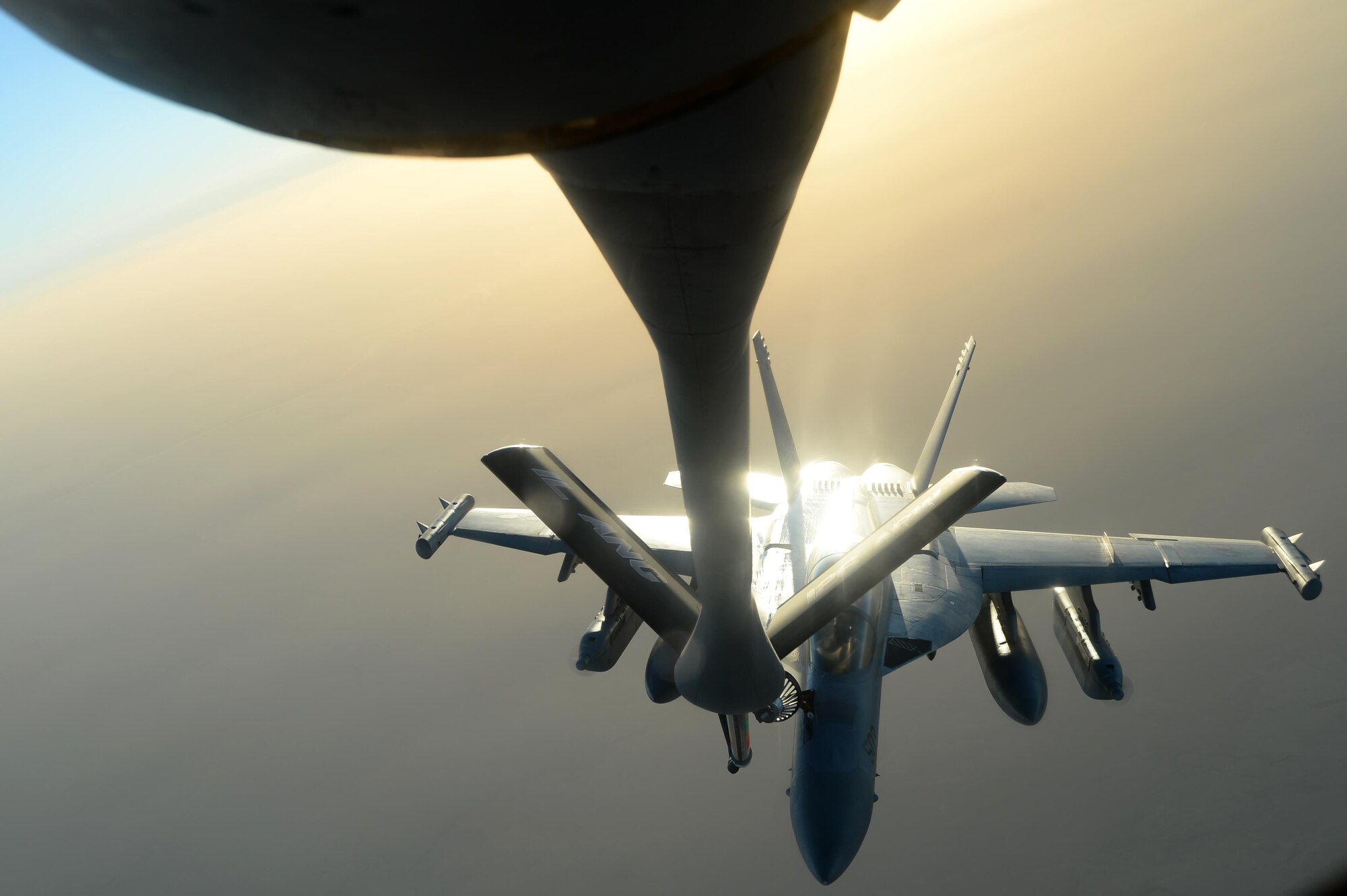 A U.S. KC-135 Stratotanker refuels a U.S. Navy EA-18G Growler over Southwest Asia in support of Operation Inherent Resolve, Aug. 20, 2015. OIR is the military intervention against Daesh. (U.S. Air Force photo by Staff Sgt. Sandra Welch)