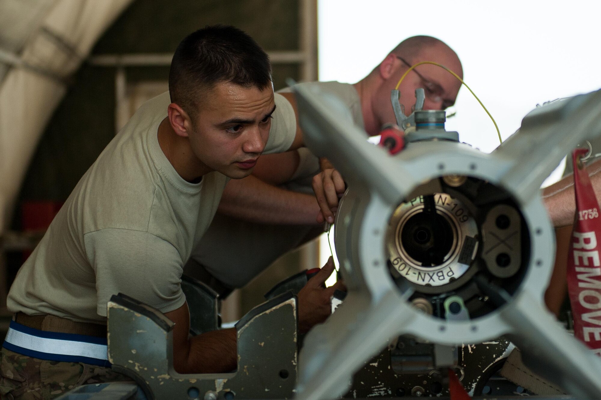 U.S. Air Force Airman 1st Class Matthew Lopez, 62nd Expeditionary Reconnaissance Squadron munitions systems technician, builds a GPS-guided GBU-49 weapon at Kandahar Airfield, Afghanistan, Aug. 15, 2015.  The 62nd ERS Munitions Flight ensures that every munition loaded onto an MQ-1 Predator and MQ-9 Reaper will perform as expected when used. (U.S. Air Force photo by Tech. Sgt. Joseph Swafford/Released)