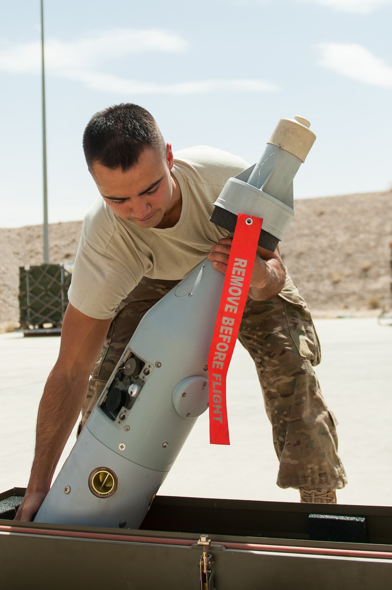 U.S. Air Force Airman 1st Class Matthew Lopez, 62nd Expeditionary Reconnaissance Squadron munitions systems technician, unpacks a piece to a GPS-guided GBU-49 weapon at Kandahar Airfield, Afghanistan, Aug. 15, 2015.  The 62nd ERS Munitions Flight ensures that every munition loaded onto an MQ-1 Predator and MQ-9 Reaper will perform as expected when used. (U.S. Air Force photo by Tech. Sgt. Joseph Swafford/Released)