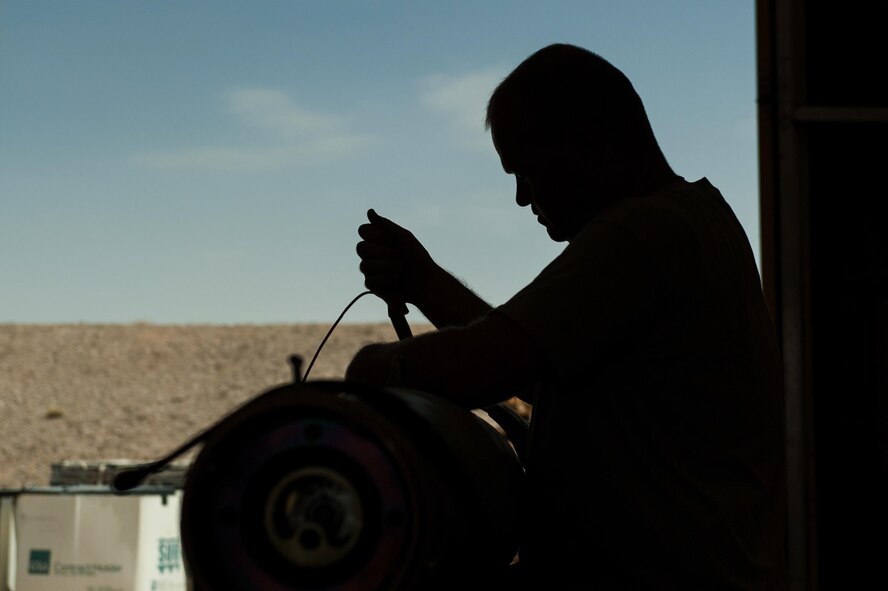 An Airman assigned to the 62nd Expeditionary Reconnaissance Squadron Munitions Flight, builds a GPS-guided GBU-49 bomb at Kandahar Airfield, Afghanistan, Aug. 15, 2015. The 62nd ERS Munitions Flight ensures that every munition loaded onto an MQ-1B Predator and MQ-9 Reaper will perform as expected when used. (U.S. Air Force photo/Tech. Sgt. Joseph Swafford)