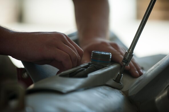 An Airman assigned to the 62nd Expeditionary Reconnaissance Squadron Munitions Flight, builds a GPS-guided GBU-49 bomb at Kandahar Airfield, Afghanistan, Aug. 15, 2015. The flight ensures that every munition loaded onto a Predator and Reaper will perform as expected when used. (U.S. Air Force photo/Tech. Sgt. Joseph Swafford)