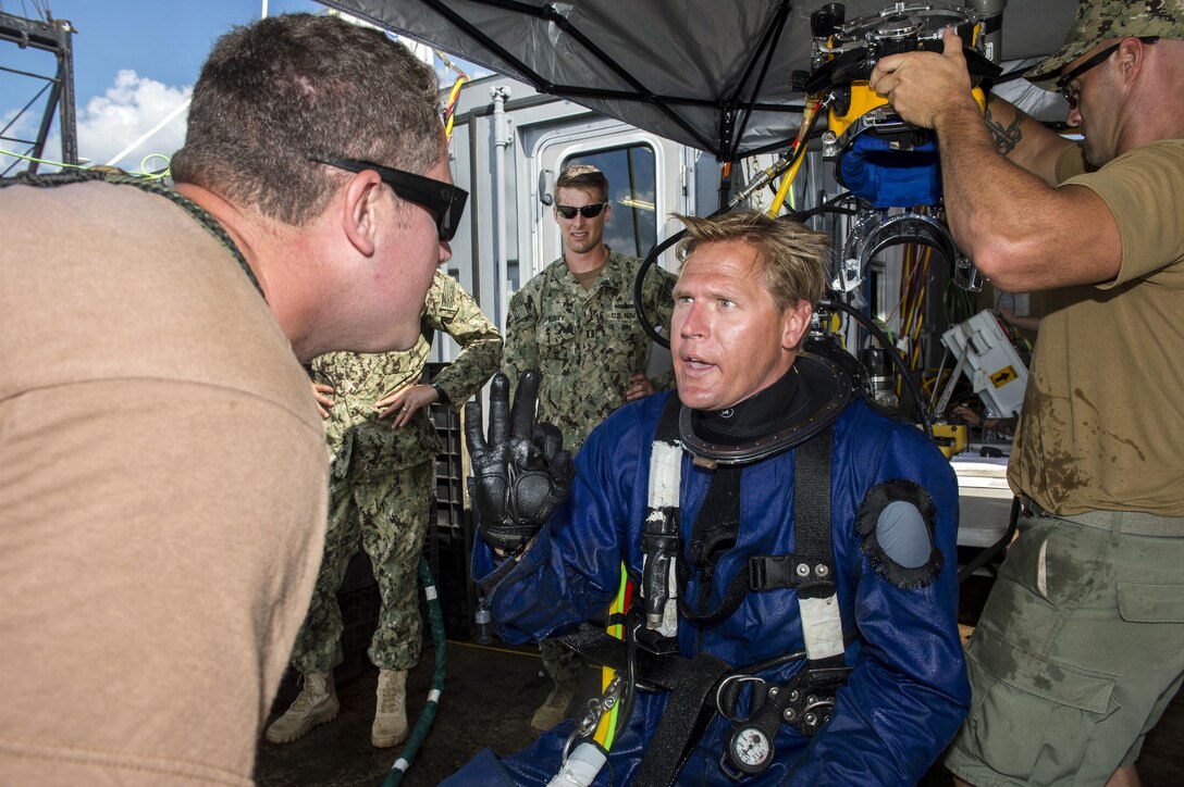 Navy Petty Officer 1st Class Travis Arneason, right, informs dive supervisor Navy Petty 1st Class Calum Sanders that he is fine after completing salvage operations on CSS Georgia steamship in the Savannah River in Savannah, Ga., Aug. 14, 2015. Arneason and Sanders are divers assigned to Mobile Diving and Salvage Unit 2. U.S. Navy photo by Petty Officer 1st Class Blake Midnight