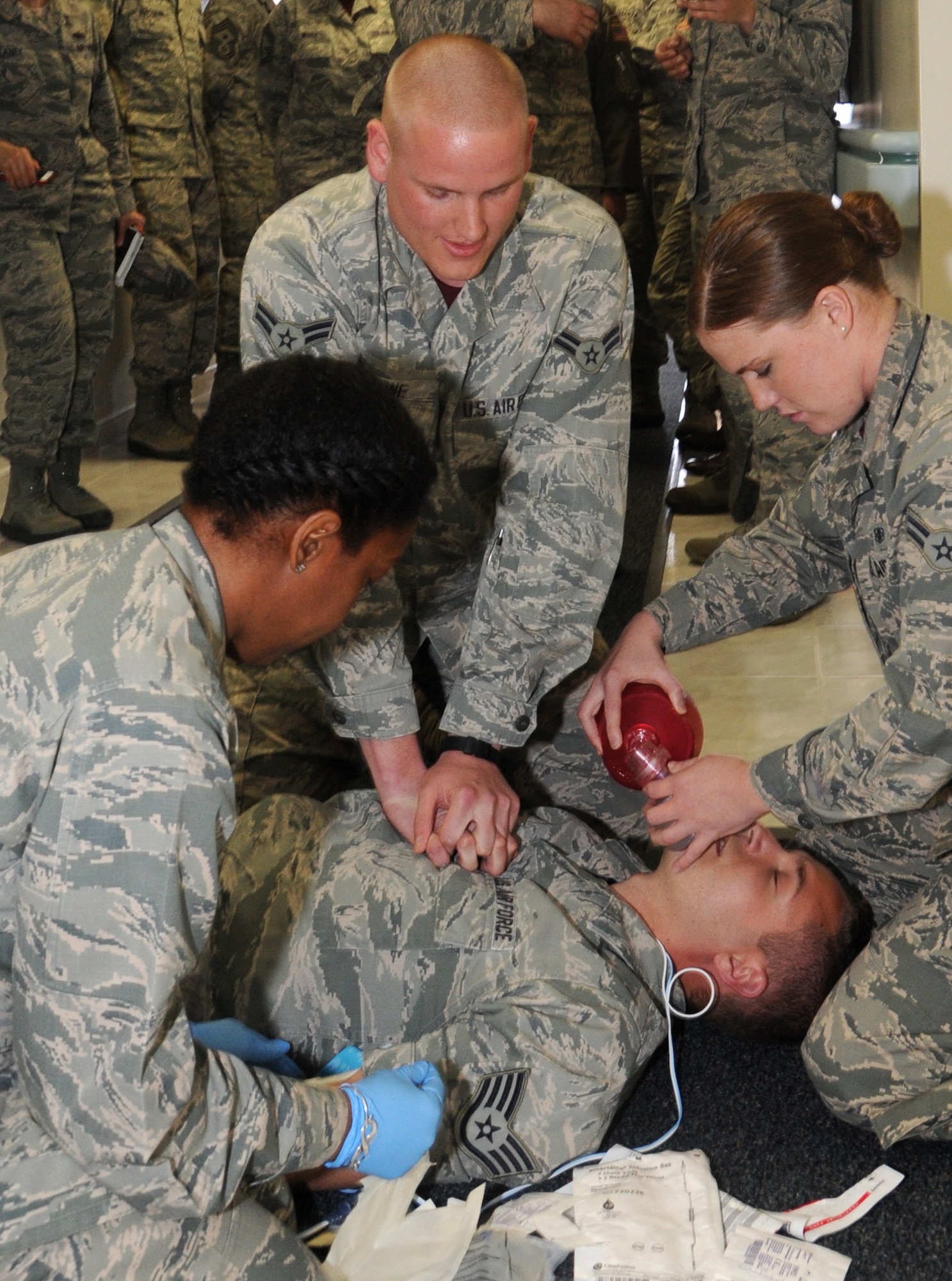 Airman 1st Class Spencer Stone, 65th Medical Operations Squadron, reacts to a mock medical emergency situation during a briefing by the 65th Medical Group for Maj. Gen. Christopher Bence, 3rd Air Force and 17th Expeditionary Air Force vice commander, on Lajes Field, Azores, Portugal, April 17, 2015. (U.S. Air Force photo by Guido Melo).
