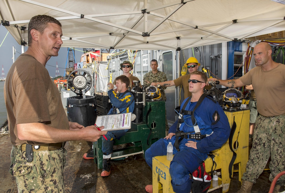 Navy Master Chief Steve Askew, left, briefs divers before conducting salvage operations of the CSS Georgia steamship in the Savannah River in Savannah, Ga., Aug. 15, 2015. Askew is a diver assigned to Mobile Diving and Salvage Unit 2. U.S. Navy photo by Petty Officer 1st Class Blake Midnight