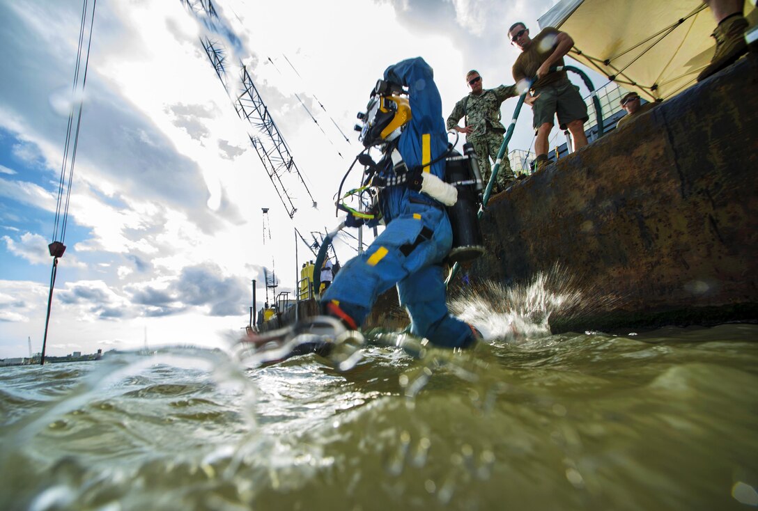 Navy Petty Officer 3rd Class Kevin Kollar jumps into the Savannah River to conduct salvage operations on SCC Georgia steamship in Savannah, Ga., Aug. 18, 2015. Kollar is a diver assigned to Mobile Diving and Salvage Unit 2. U.S. Navy photo by Petty Officer 1st Class Blake Midnight